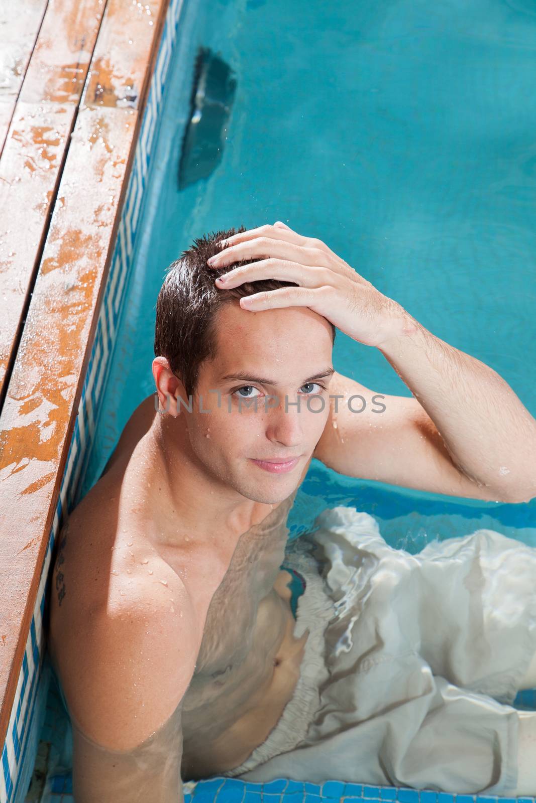 Serious man resting in the edge of the pool
