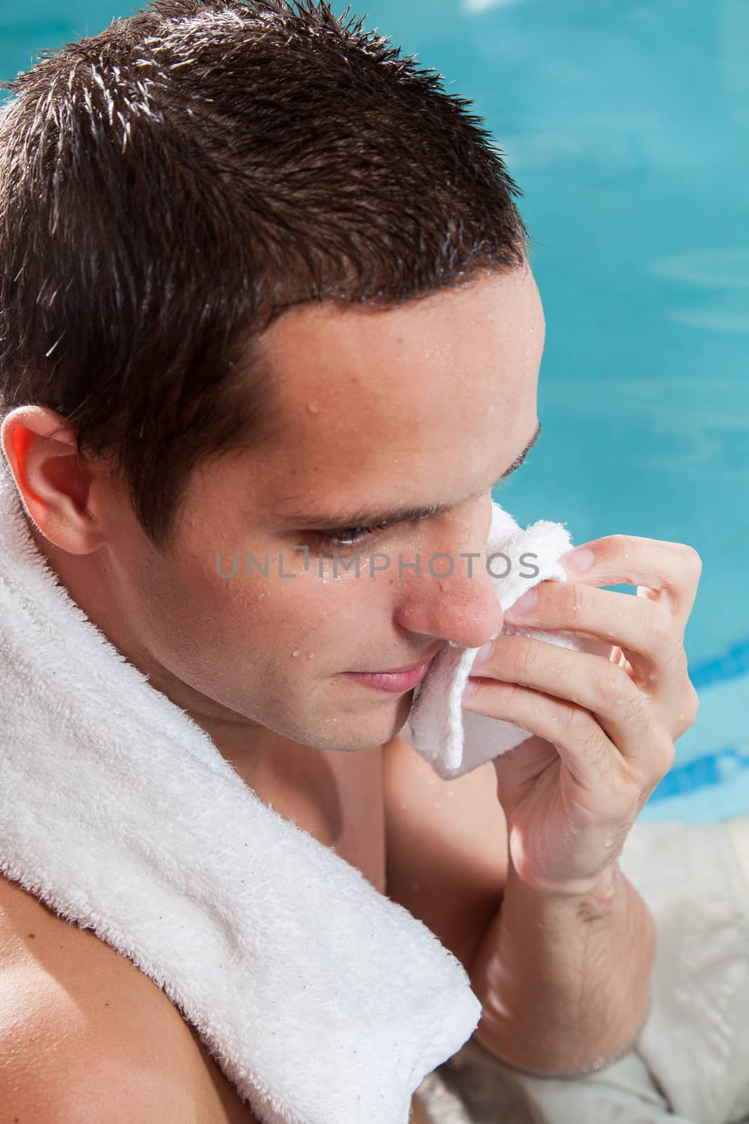 Man with a towel inside the pool