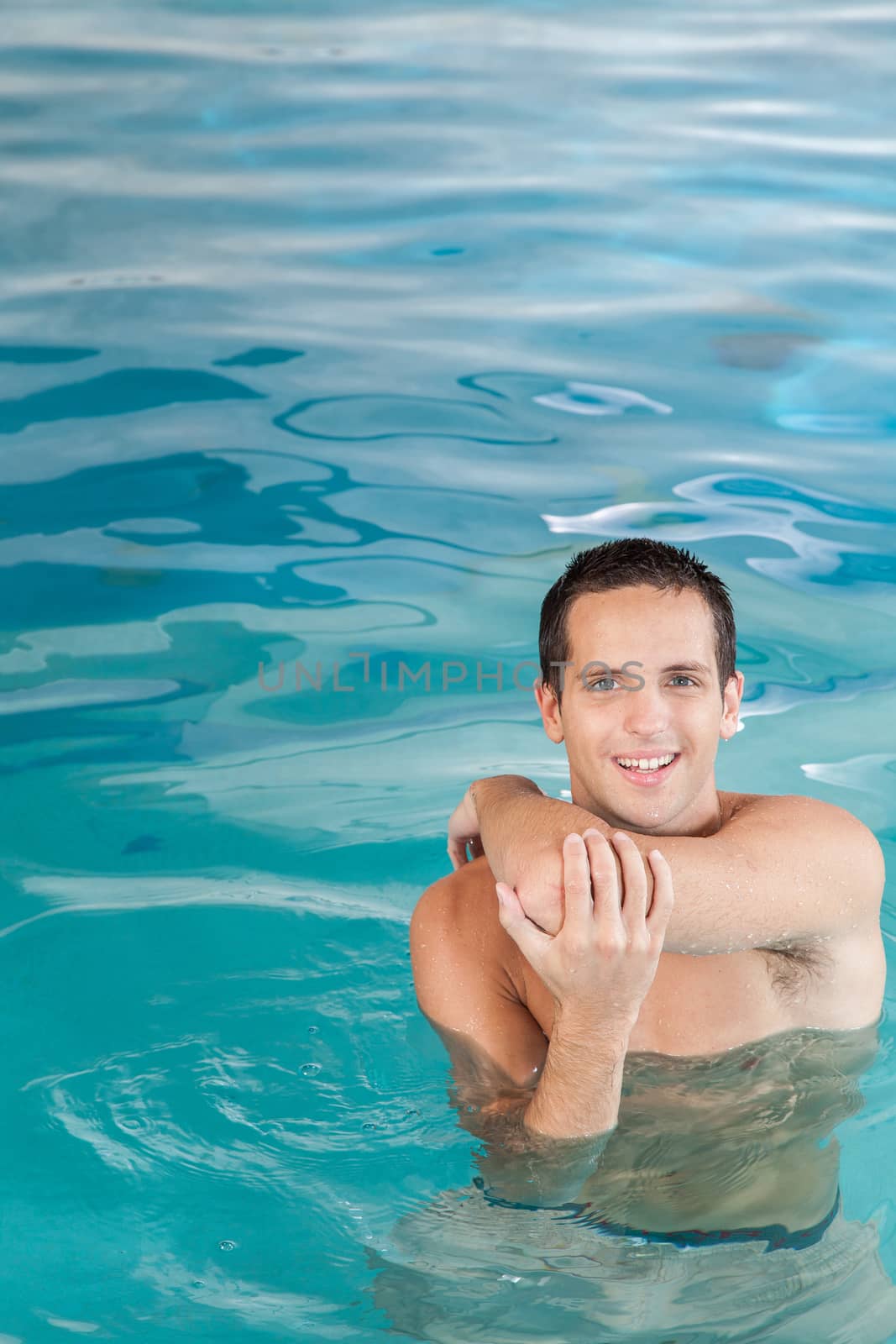 Athletic guy inside the pool