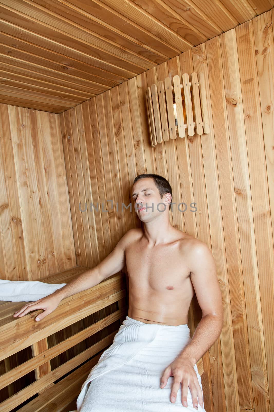 Guy resting inside the sauna