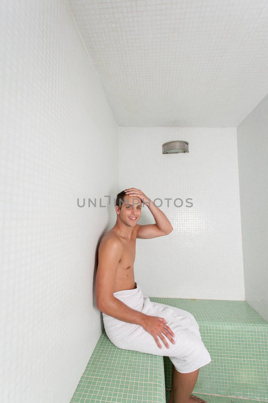 Happy man rest inside the sauna