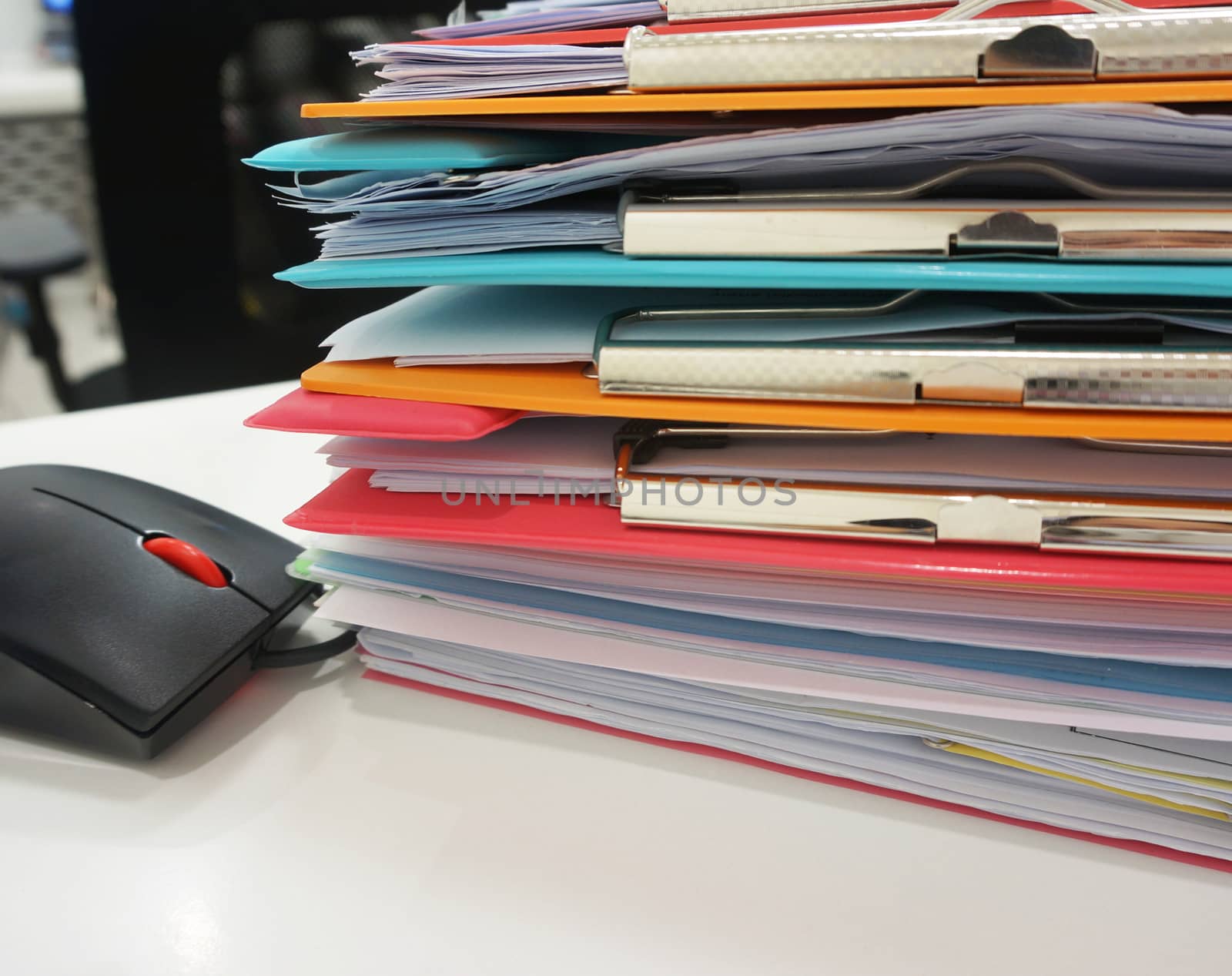 Stack of many color clipboard and computer mouse by ninun