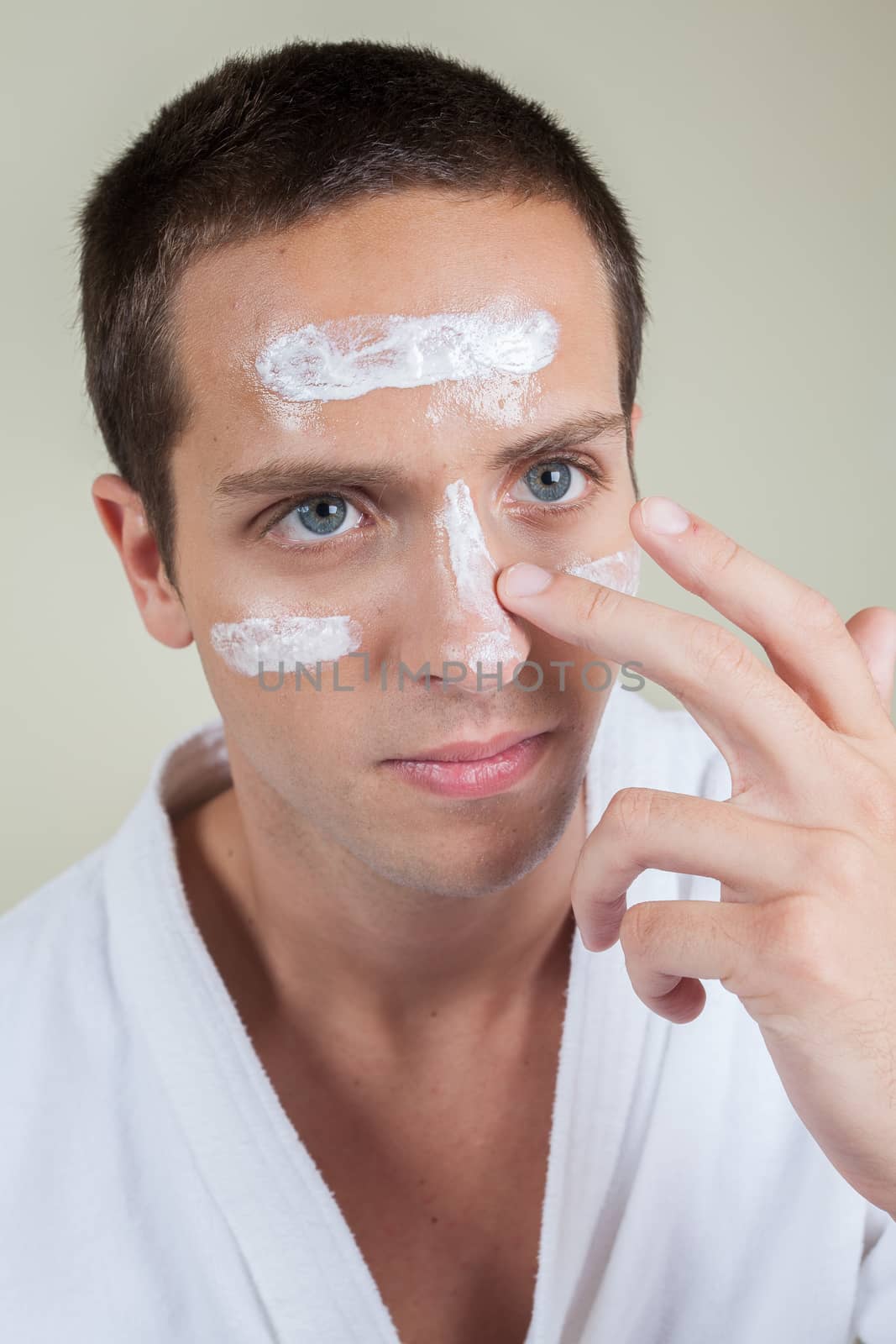 Man applying cream on face