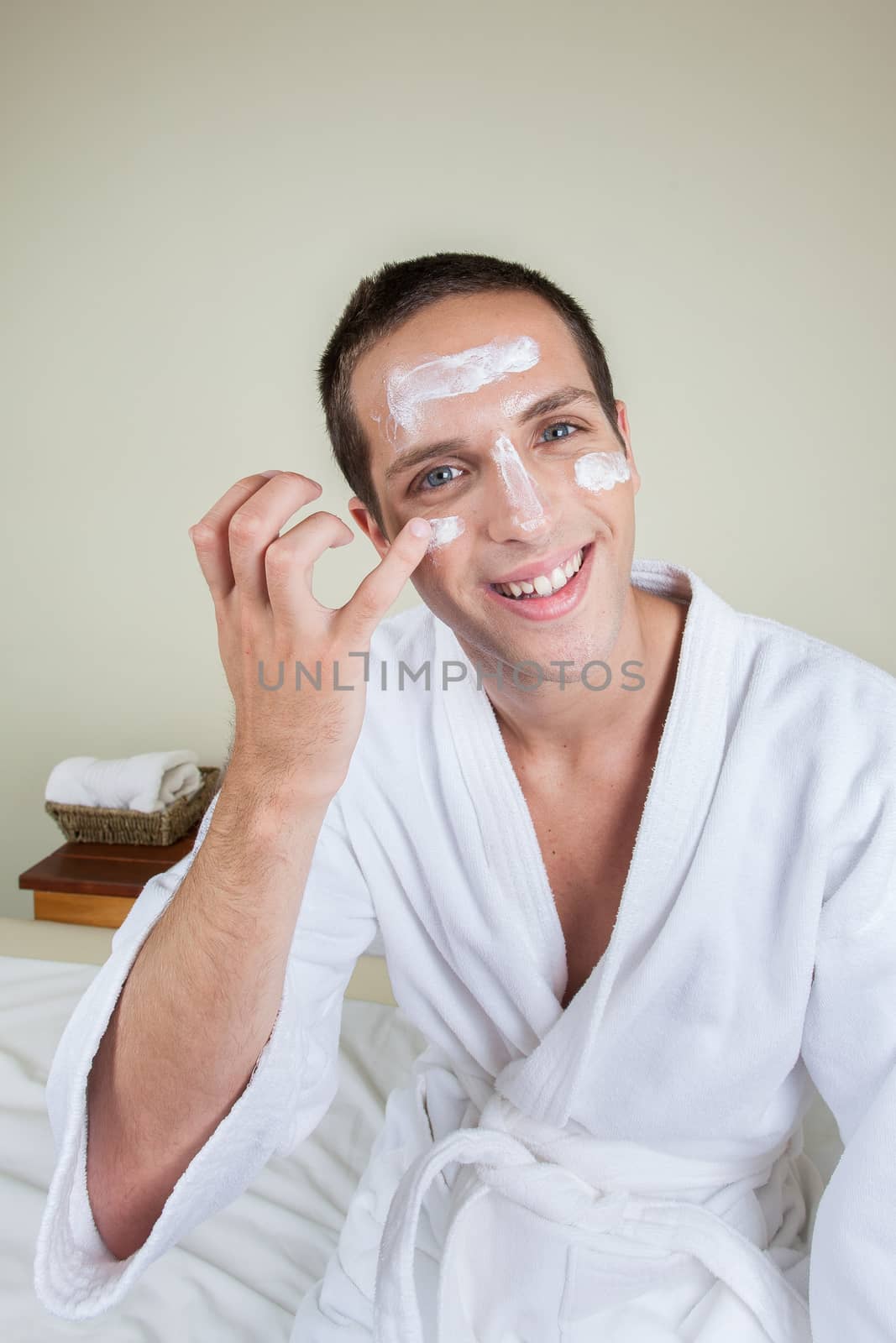 Guy putting on face cream