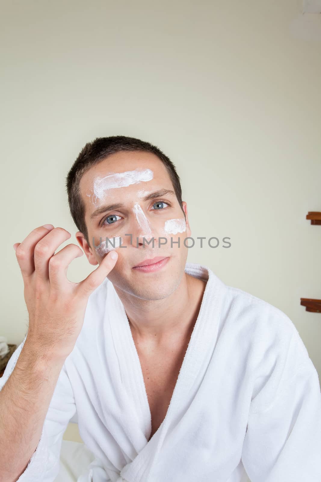 Man putting on face cream