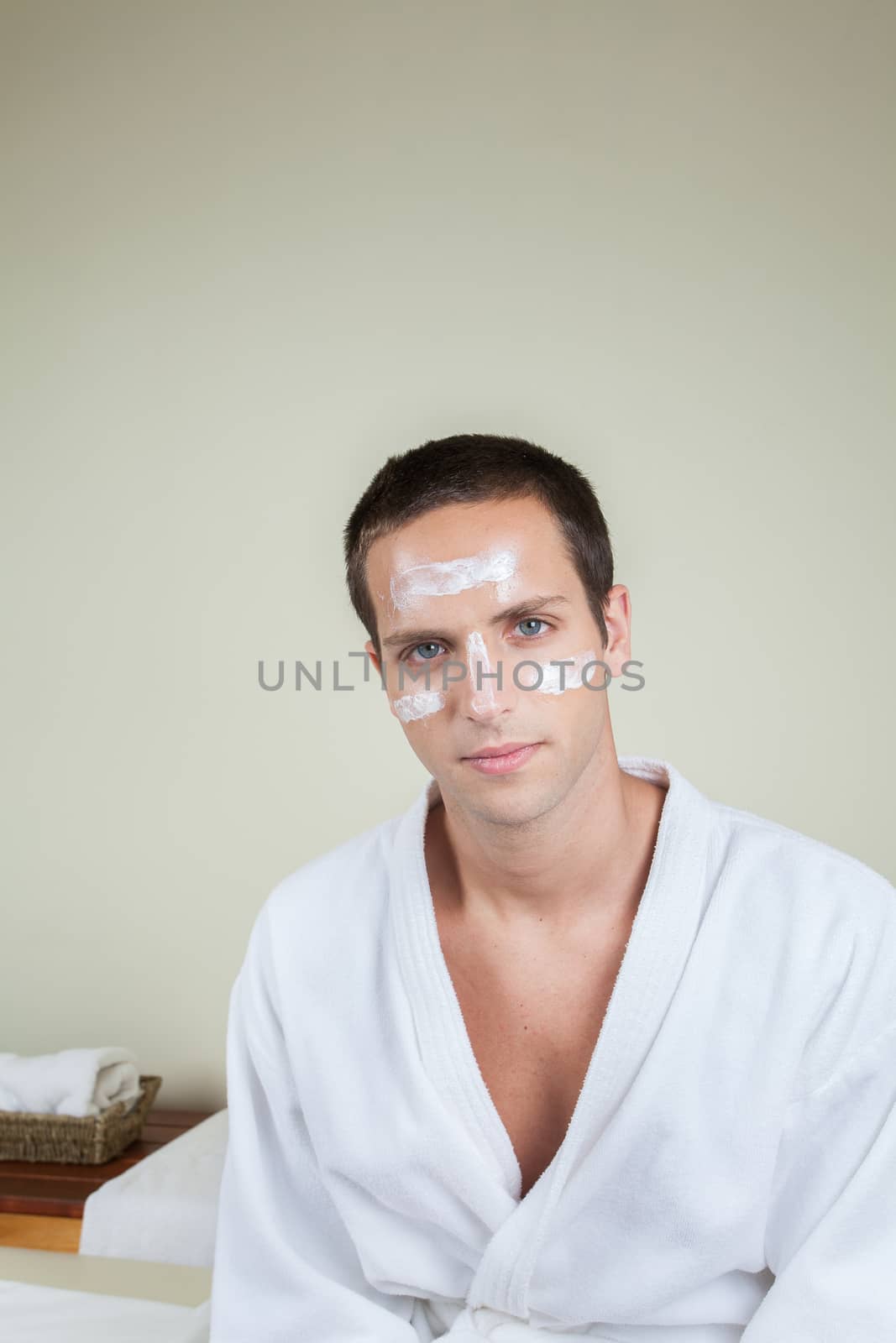 Serious guy with cream on her face by ifilms