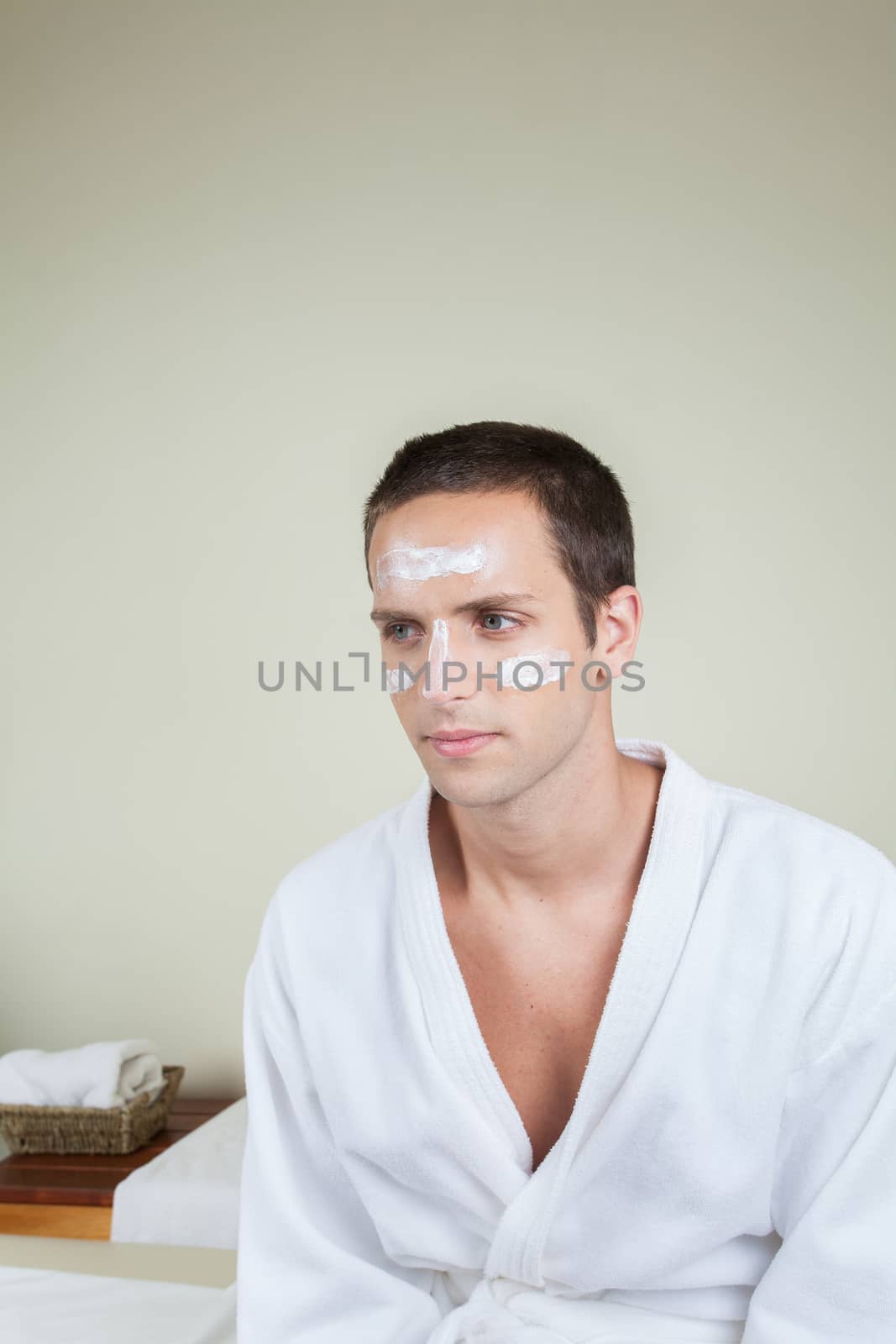 Serious guy with cream on her face