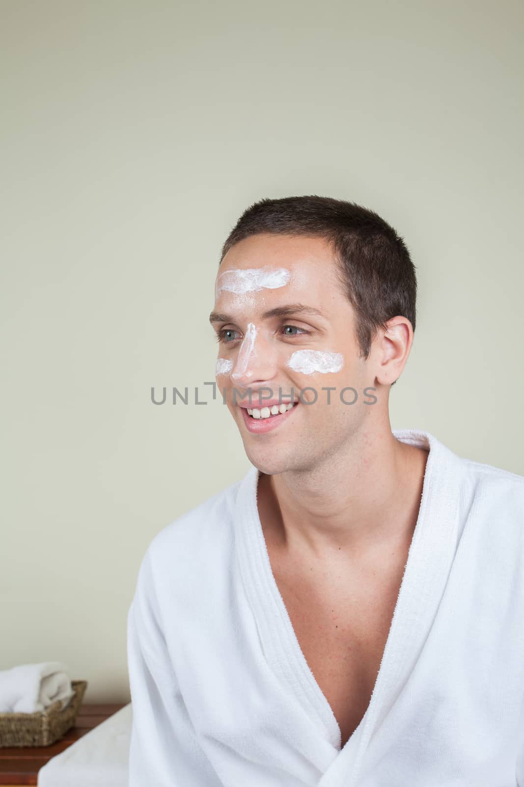 Smiling man with cream on her face by ifilms