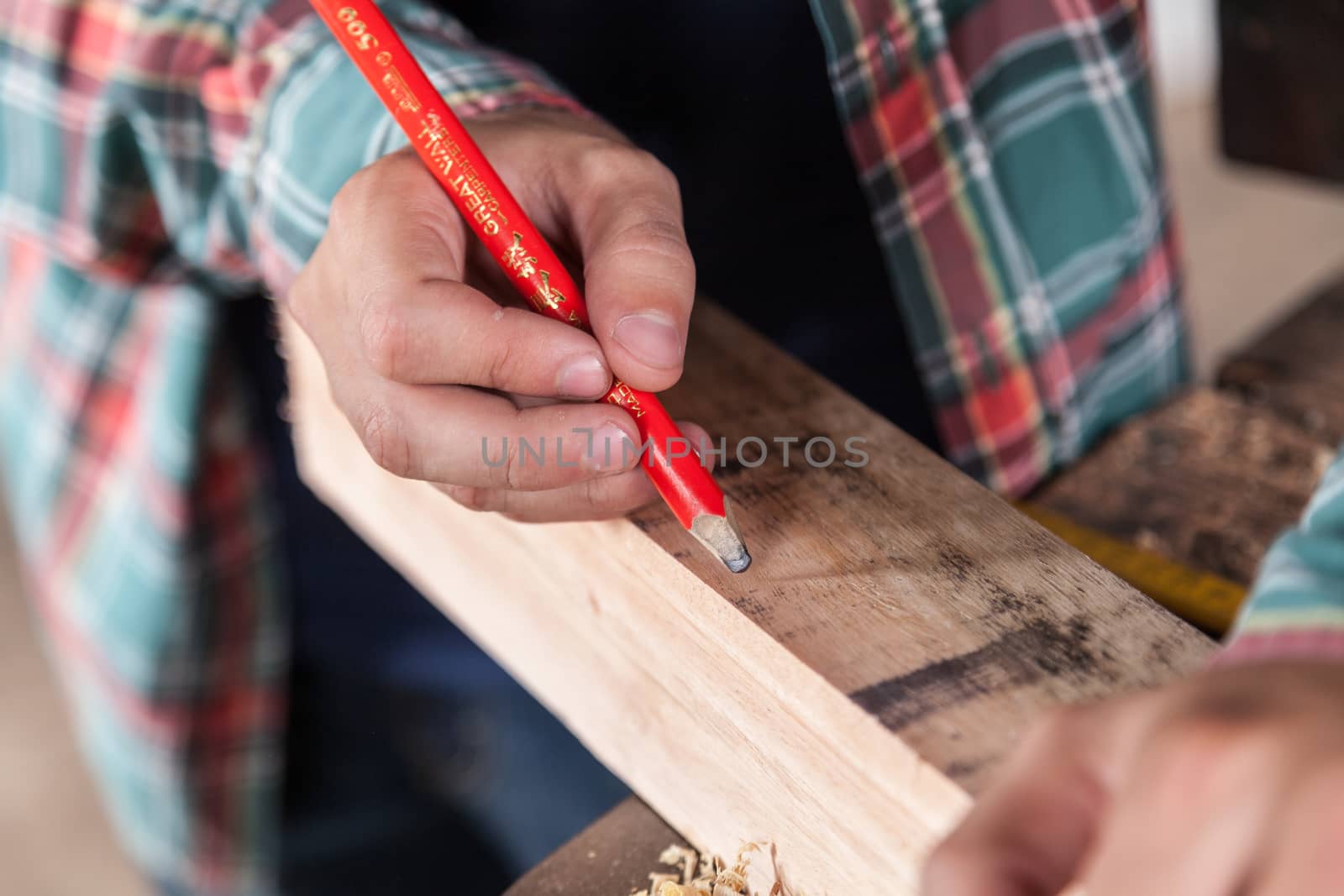 Guy marking wood with a pencil by ifilms