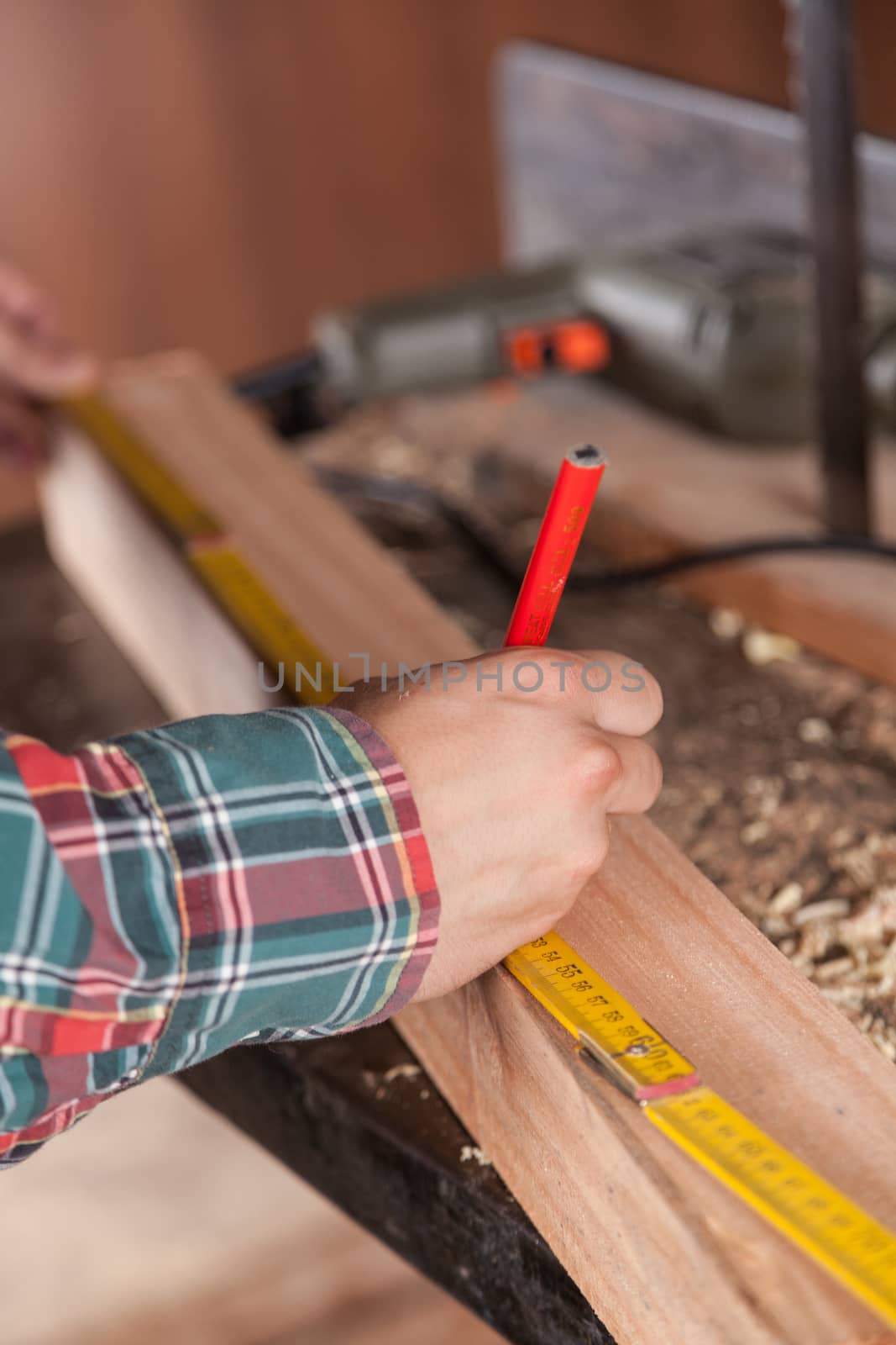 Man measuring a piece of wood by ifilms