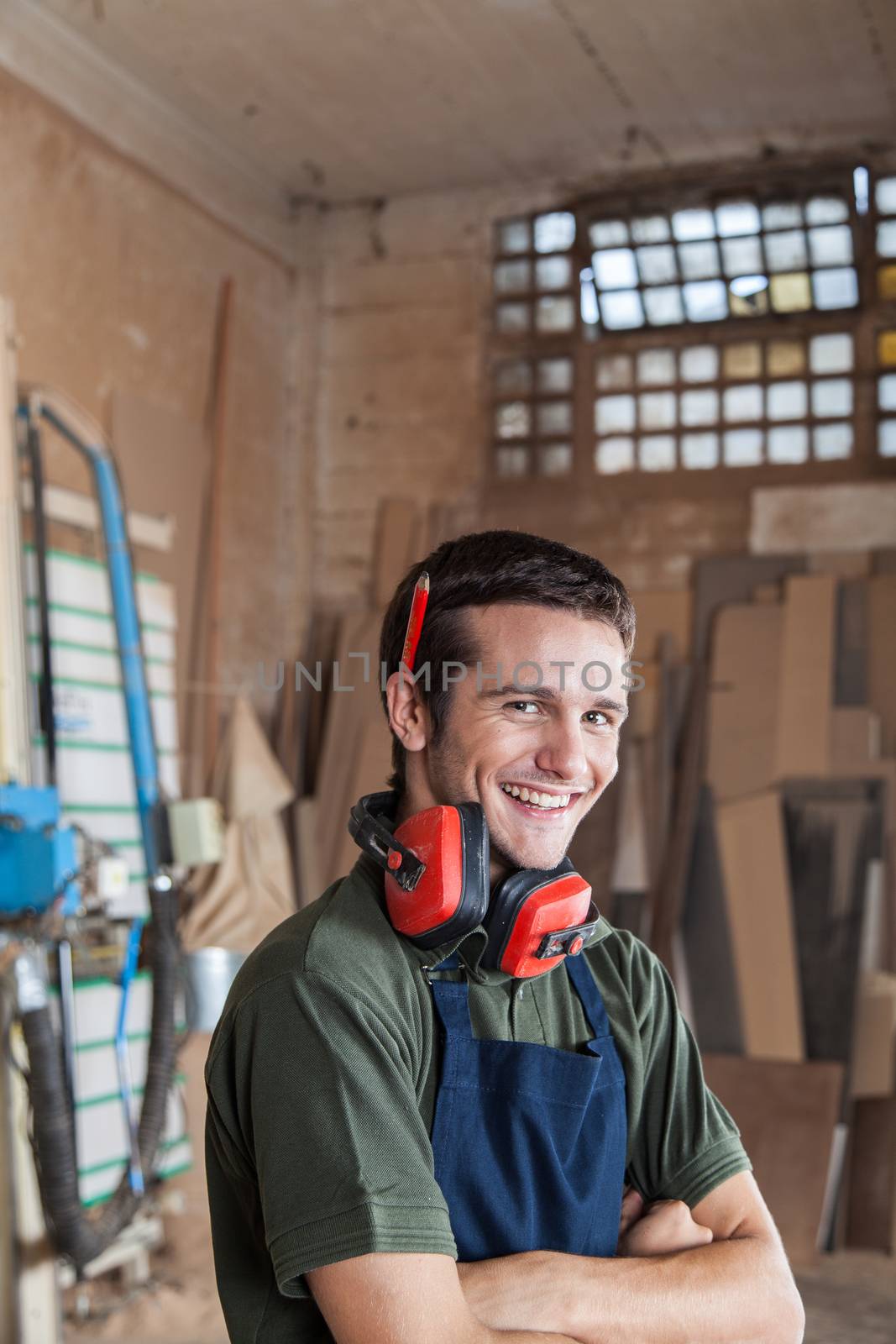 Carpenter smiling with protectors hearing by ifilms