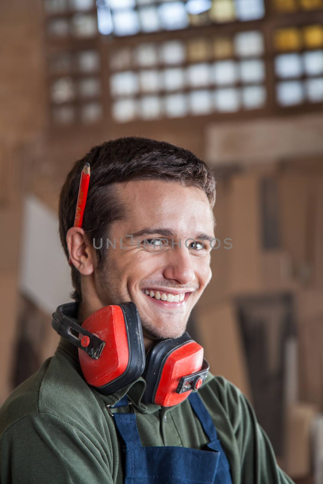 Carpenter smiling with protectors hearing