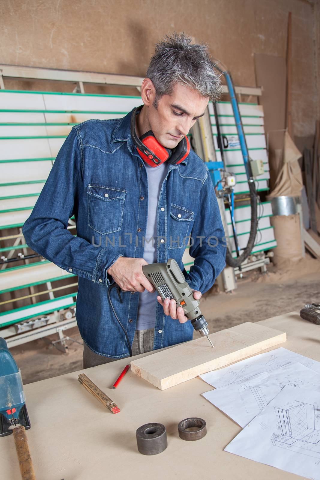 Man working with a drill by ifilms