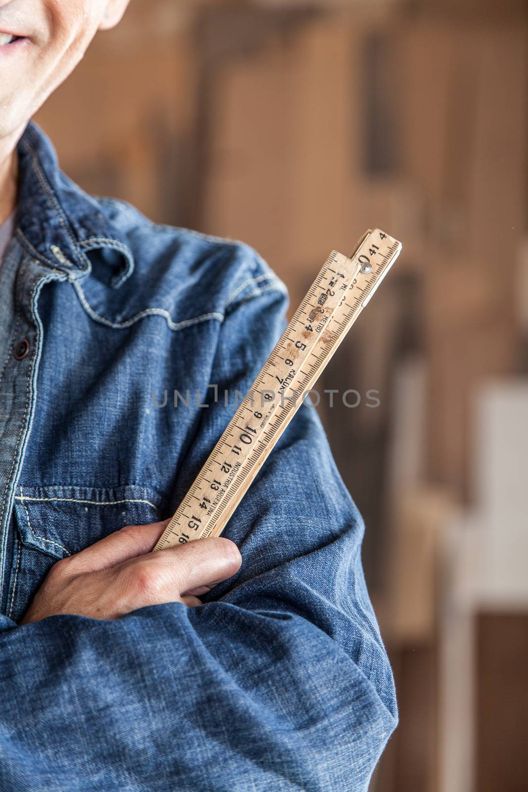 Carpenter holding a ruler