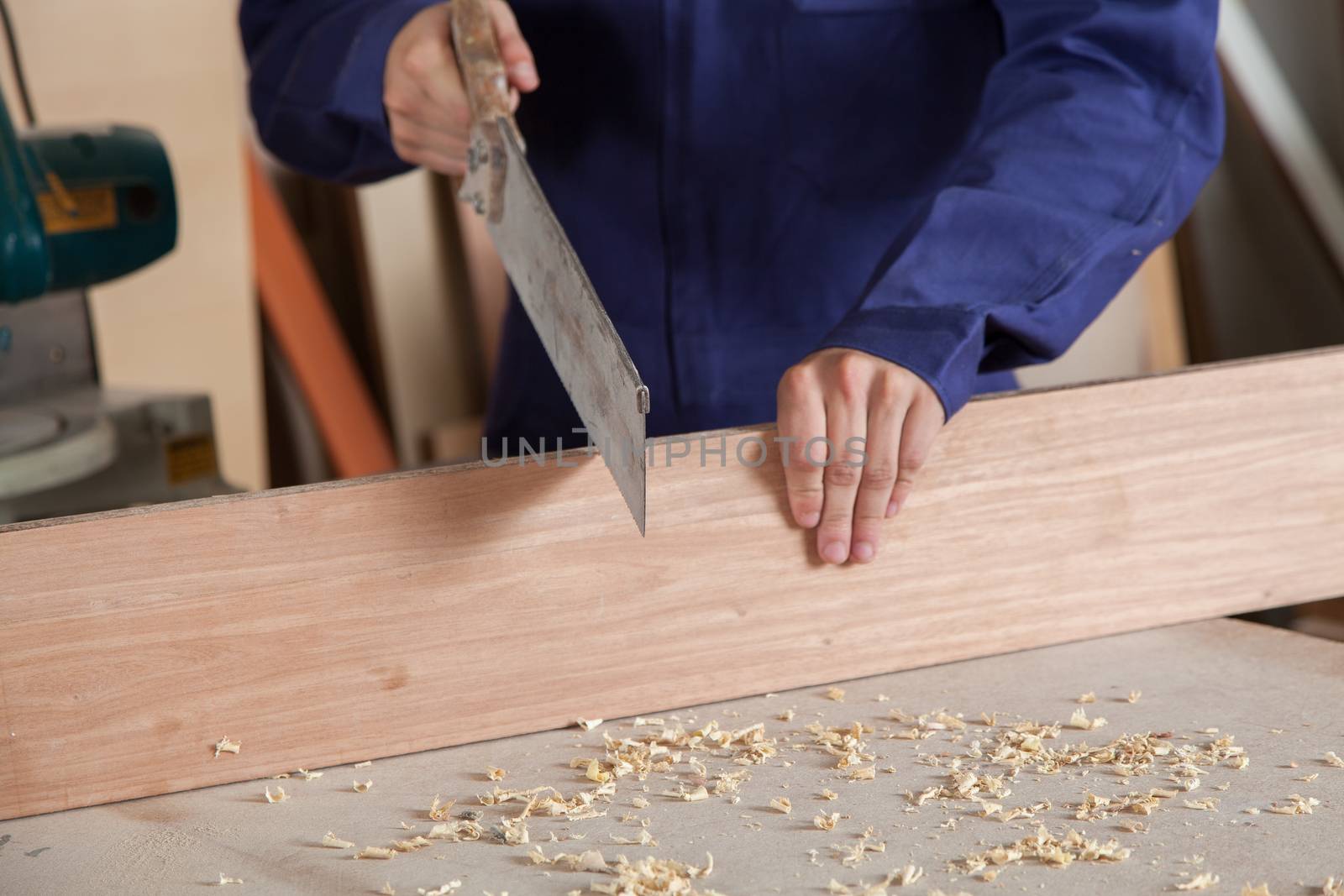 Carpenter cutting a piece ok wood by ifilms
