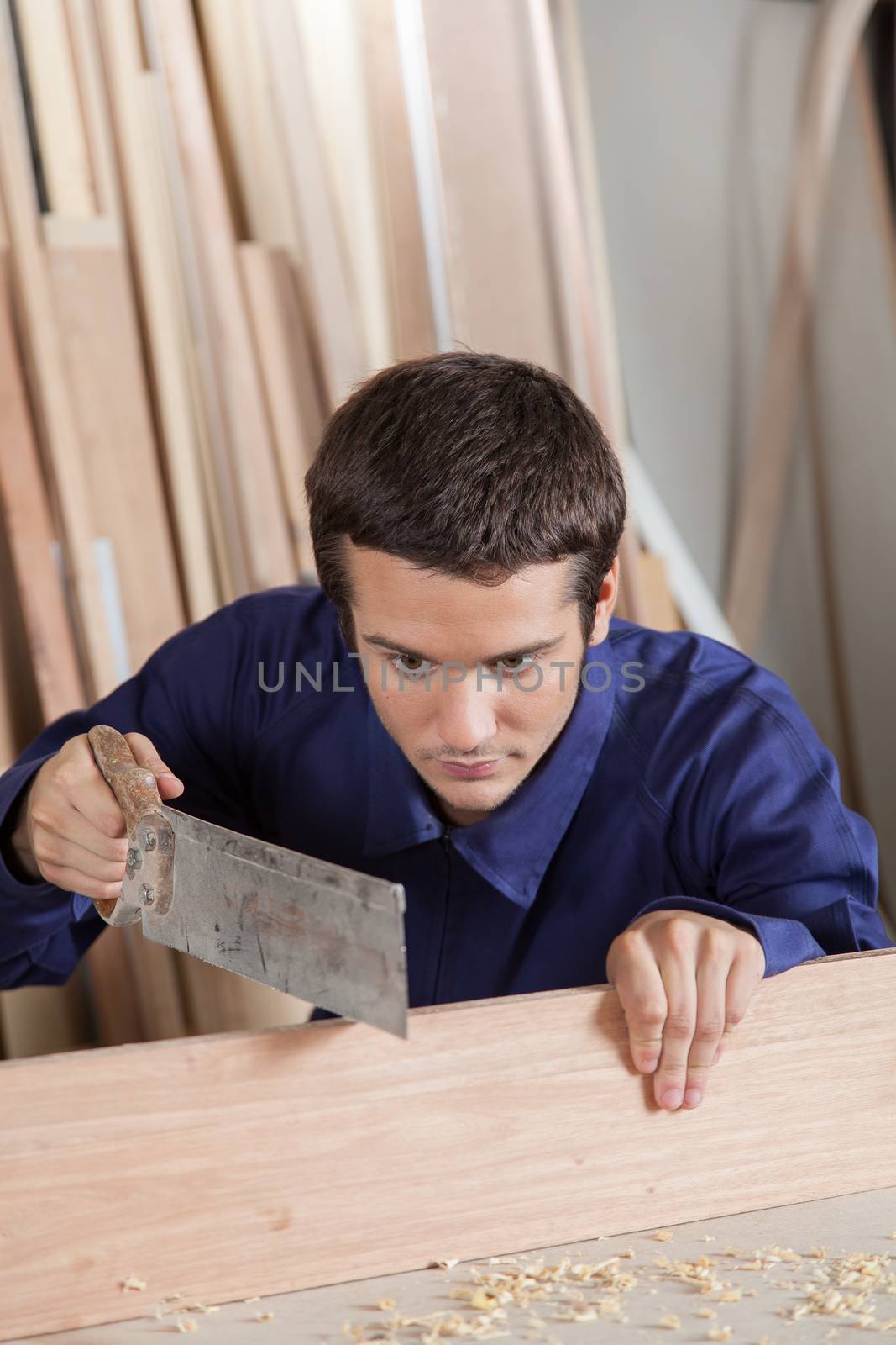 Man cutting a plank