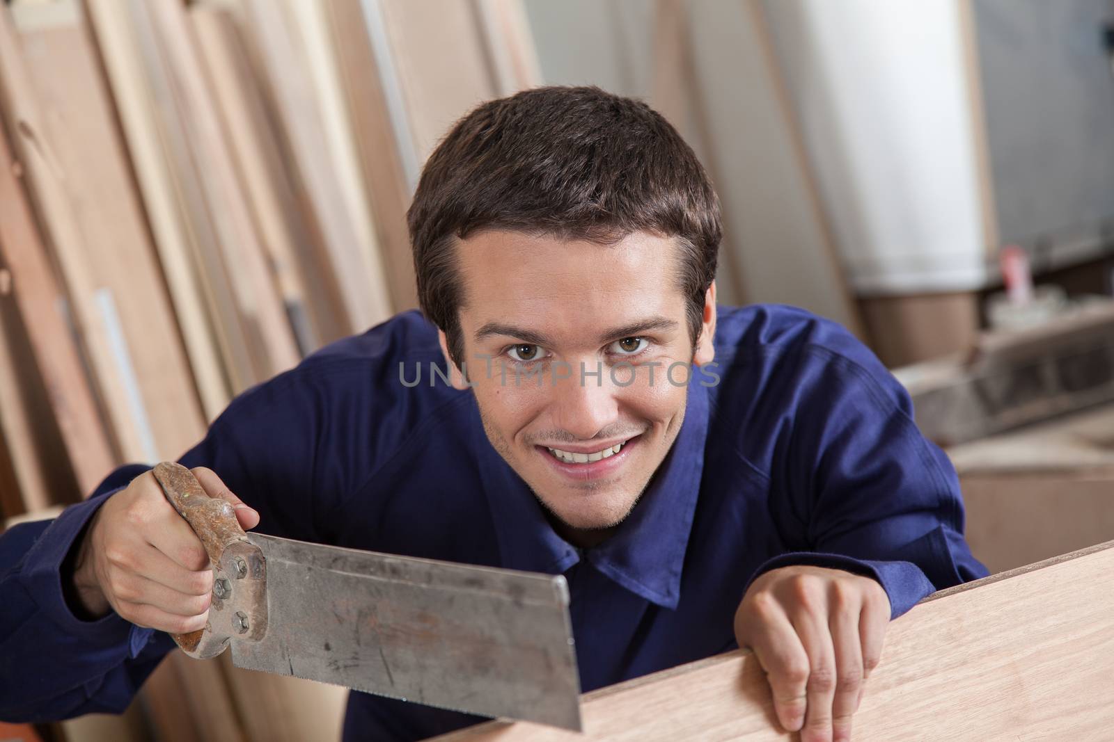 Happy man using a saw by ifilms
