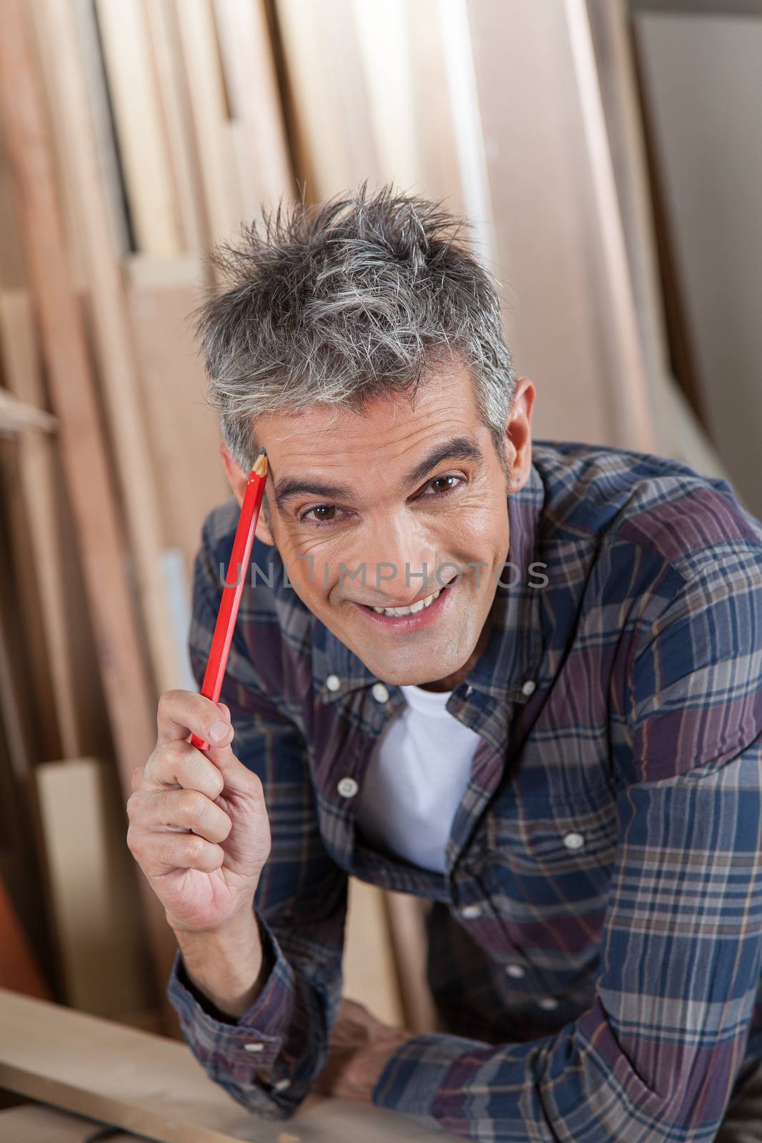 Carpenter holding a pencil