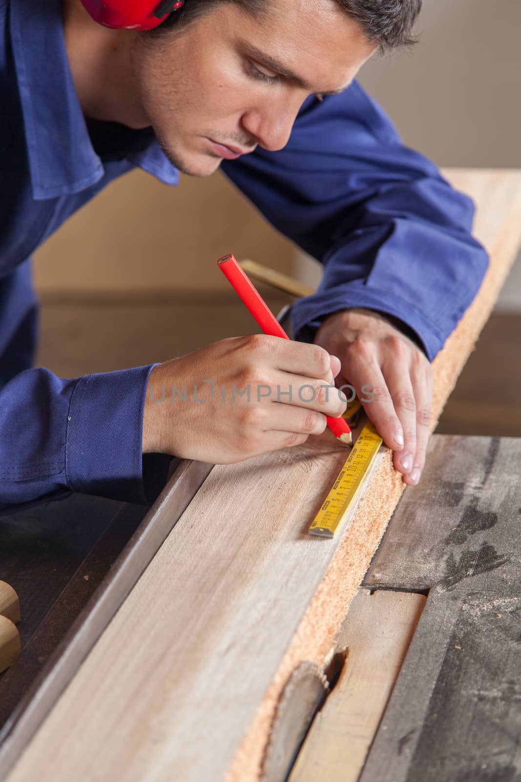 Carpenter marking a piece of wood
