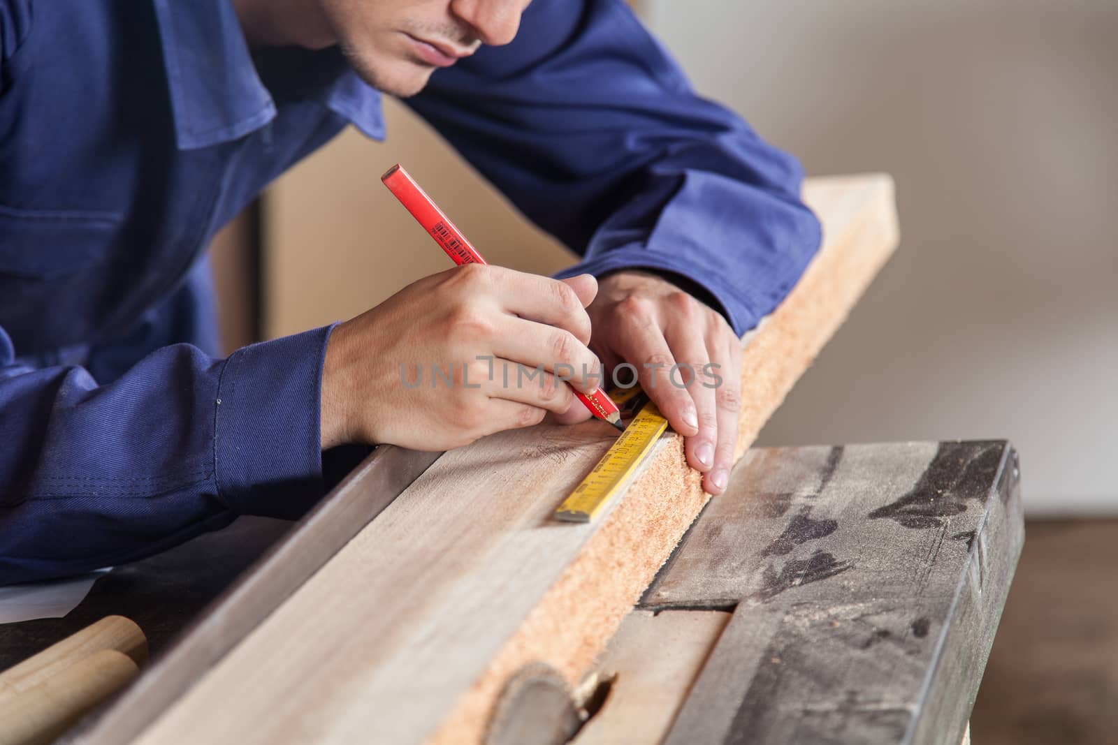 Carpenter marking a piece of wood by ifilms