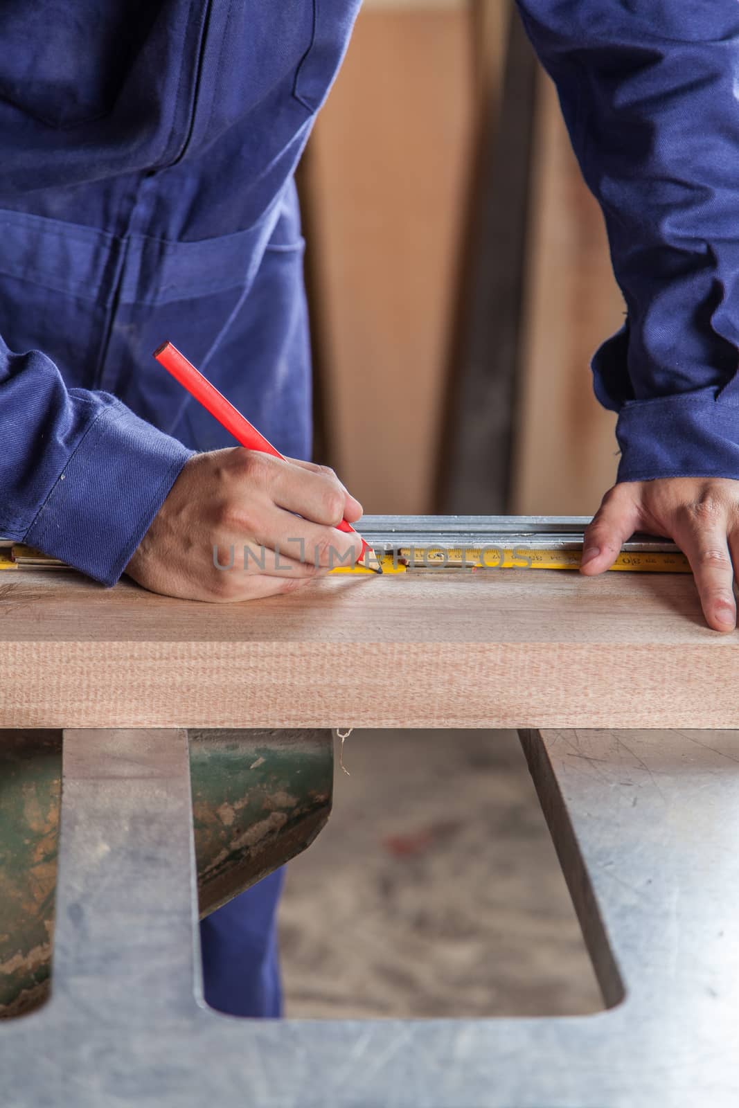 Carpenter marking a plank