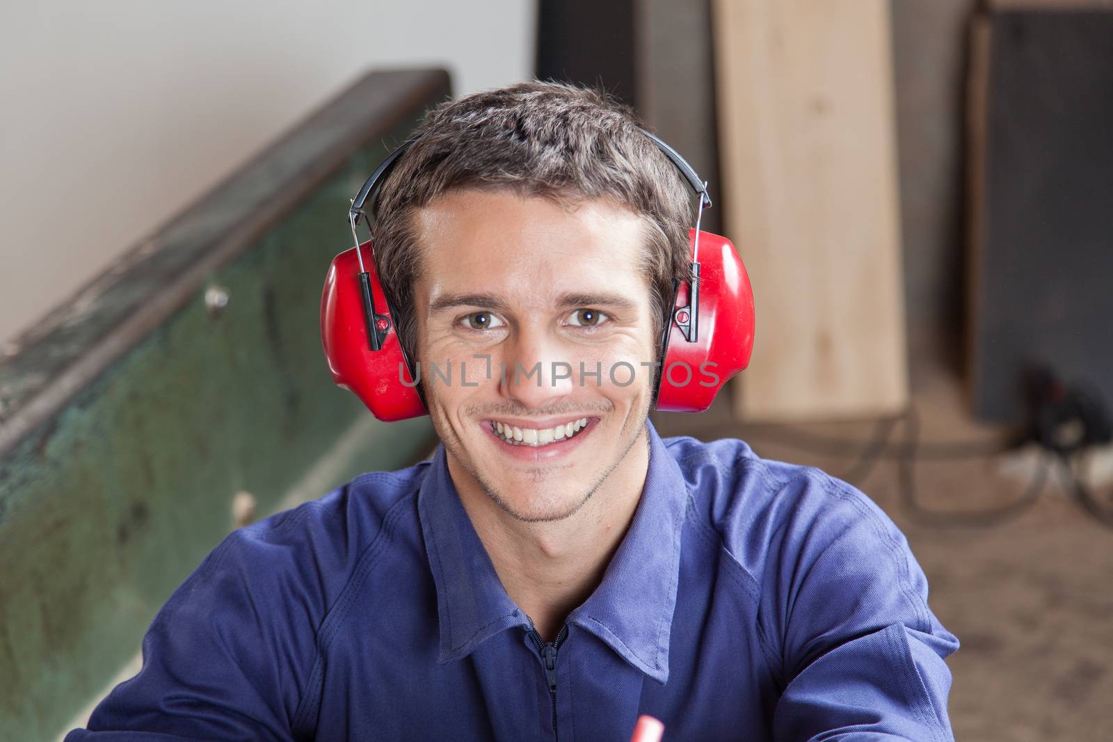 Smiling carpenter with headphones
