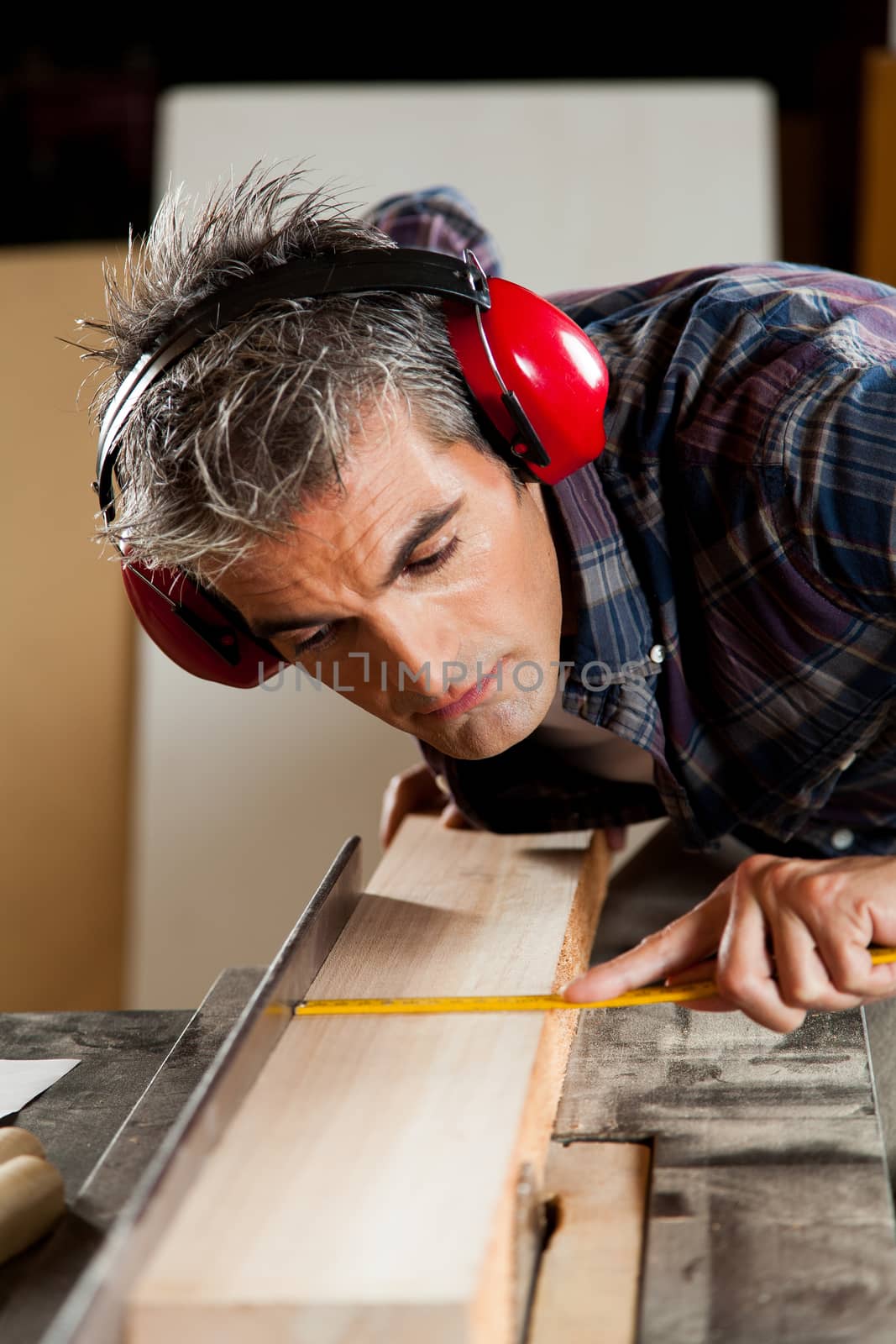Carpenter measuring a piece of wood