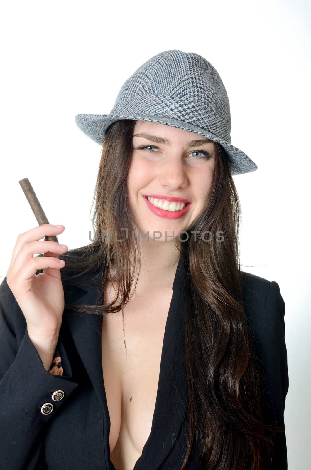Smiling girl holds cigar. Young female model with classic hat and dark tail-coat. 