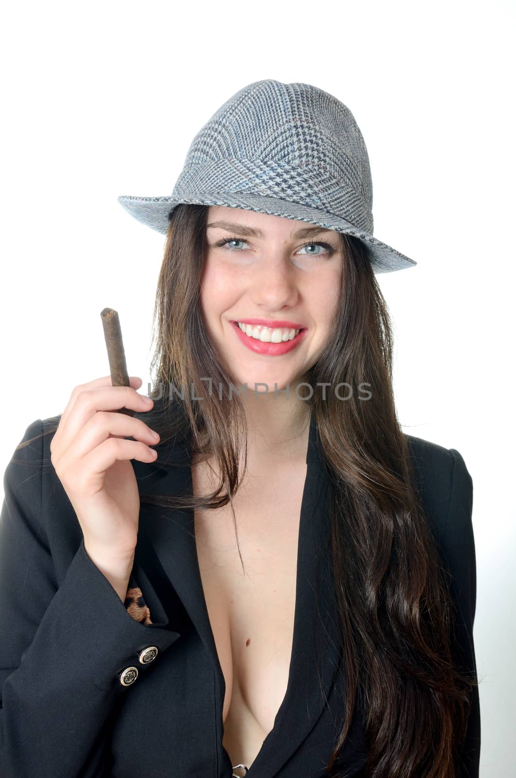 Smiling girl holds cigar. Young female model with classic hat and dark tail-coat. 