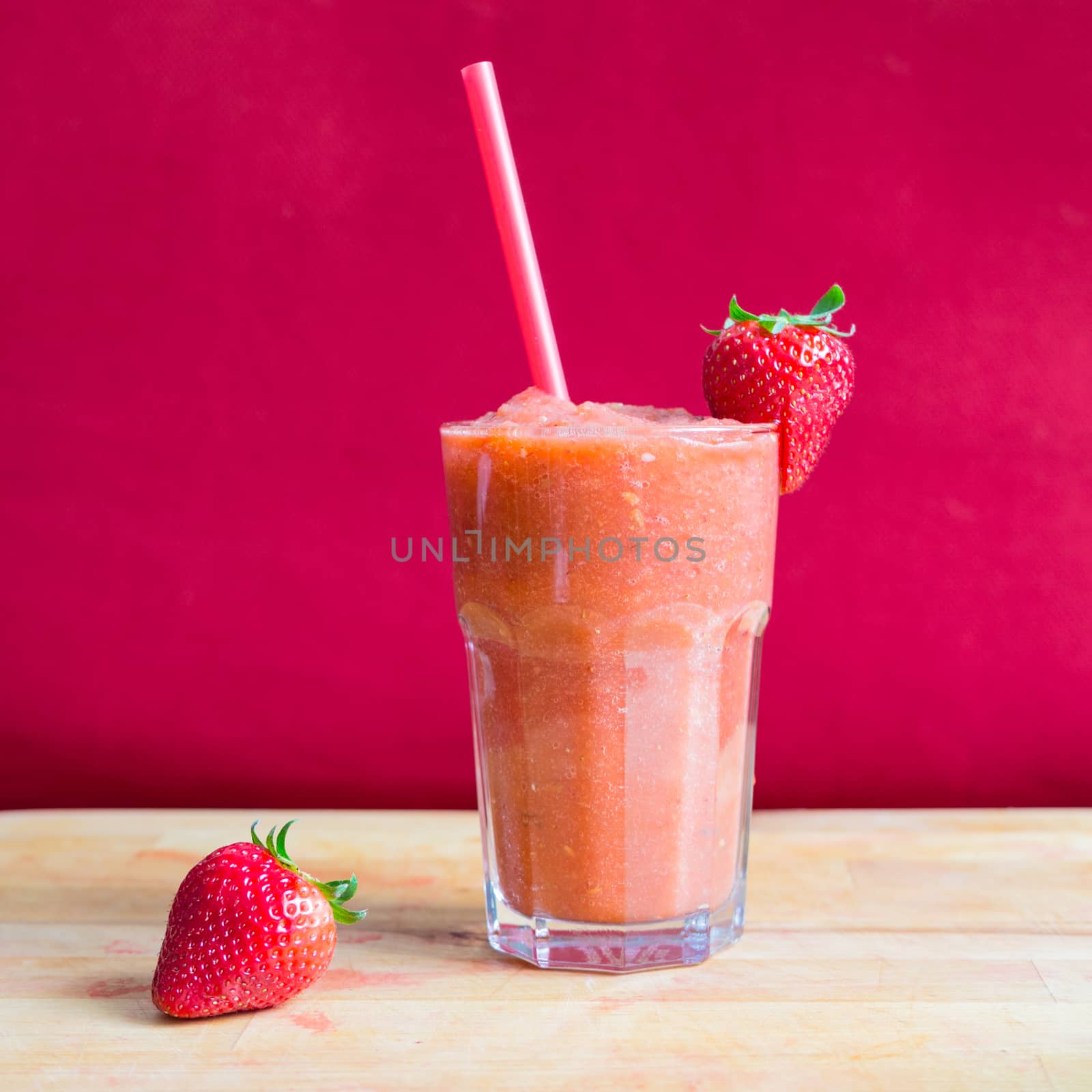 Strawberry smoothie in glass with straw by weruskak