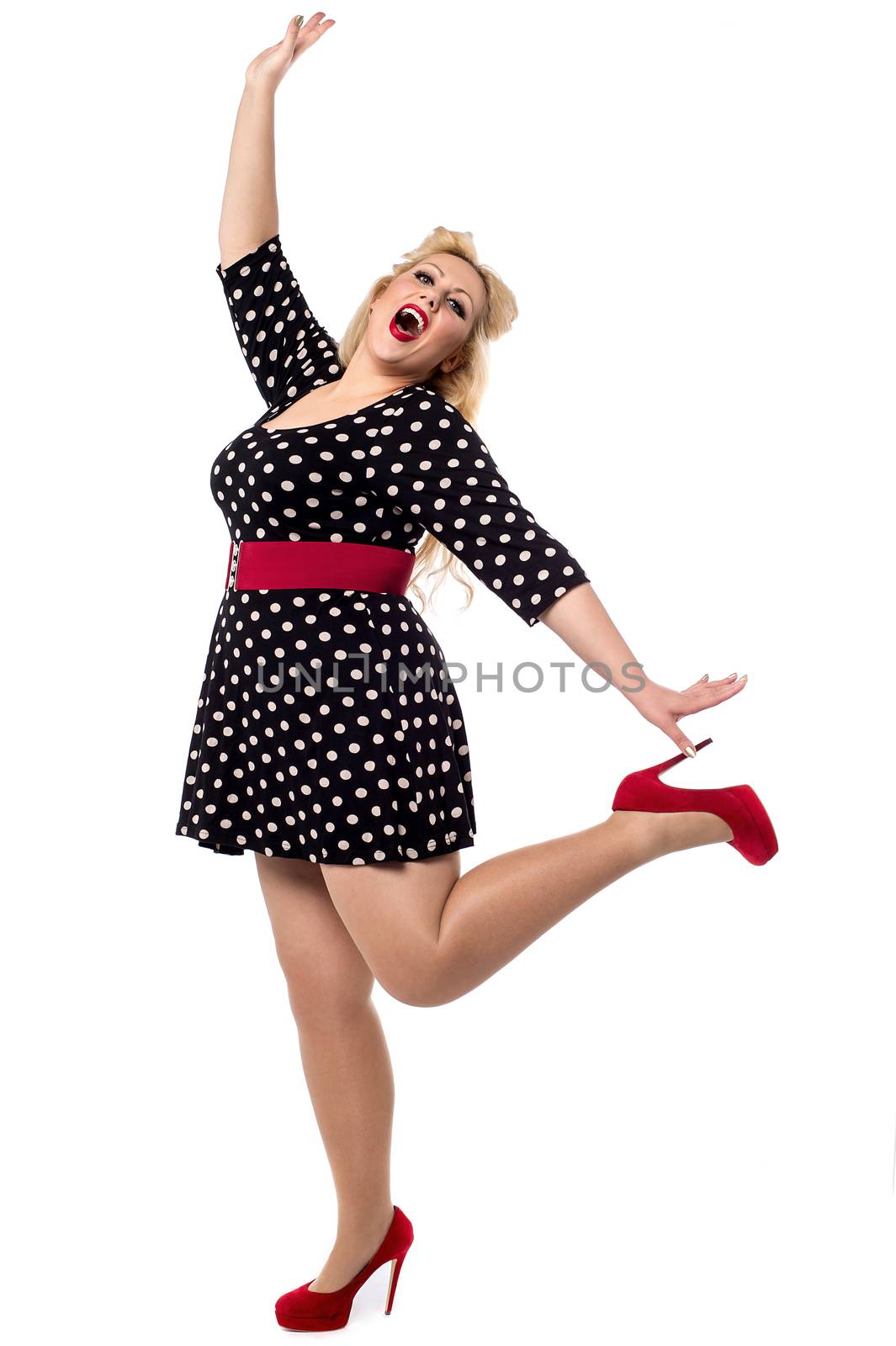 Excited woman posing in one leg by stockyimages
