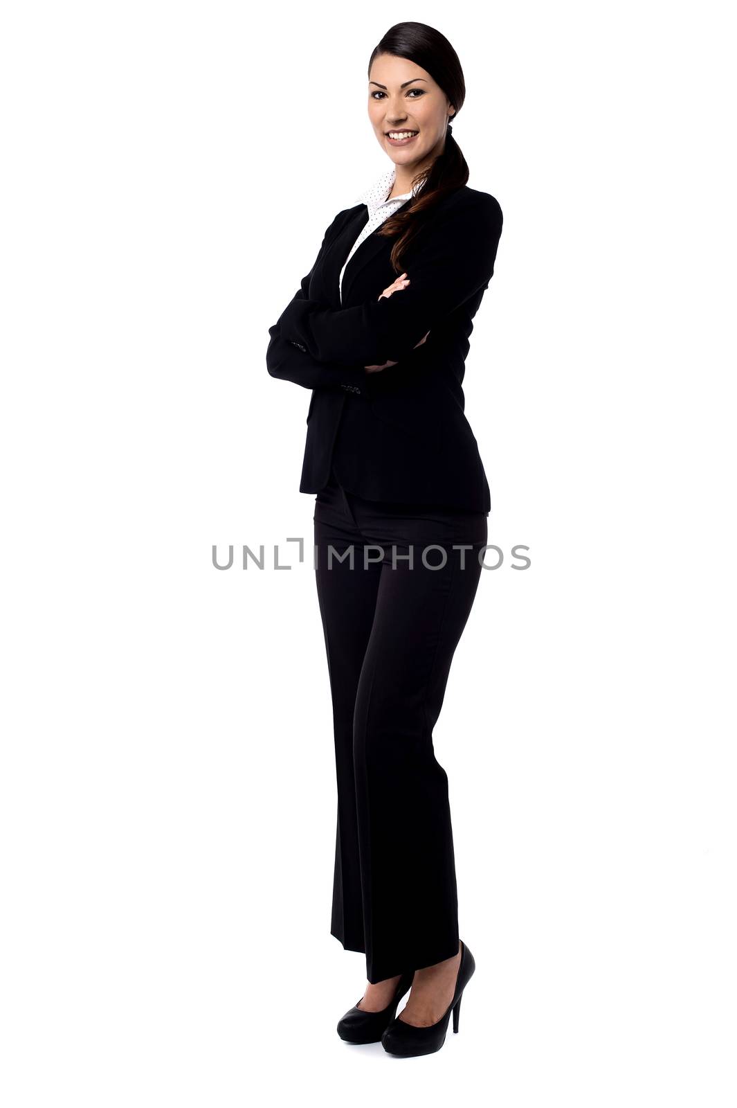 Happy businesswoman with folded arms.  by stockyimages