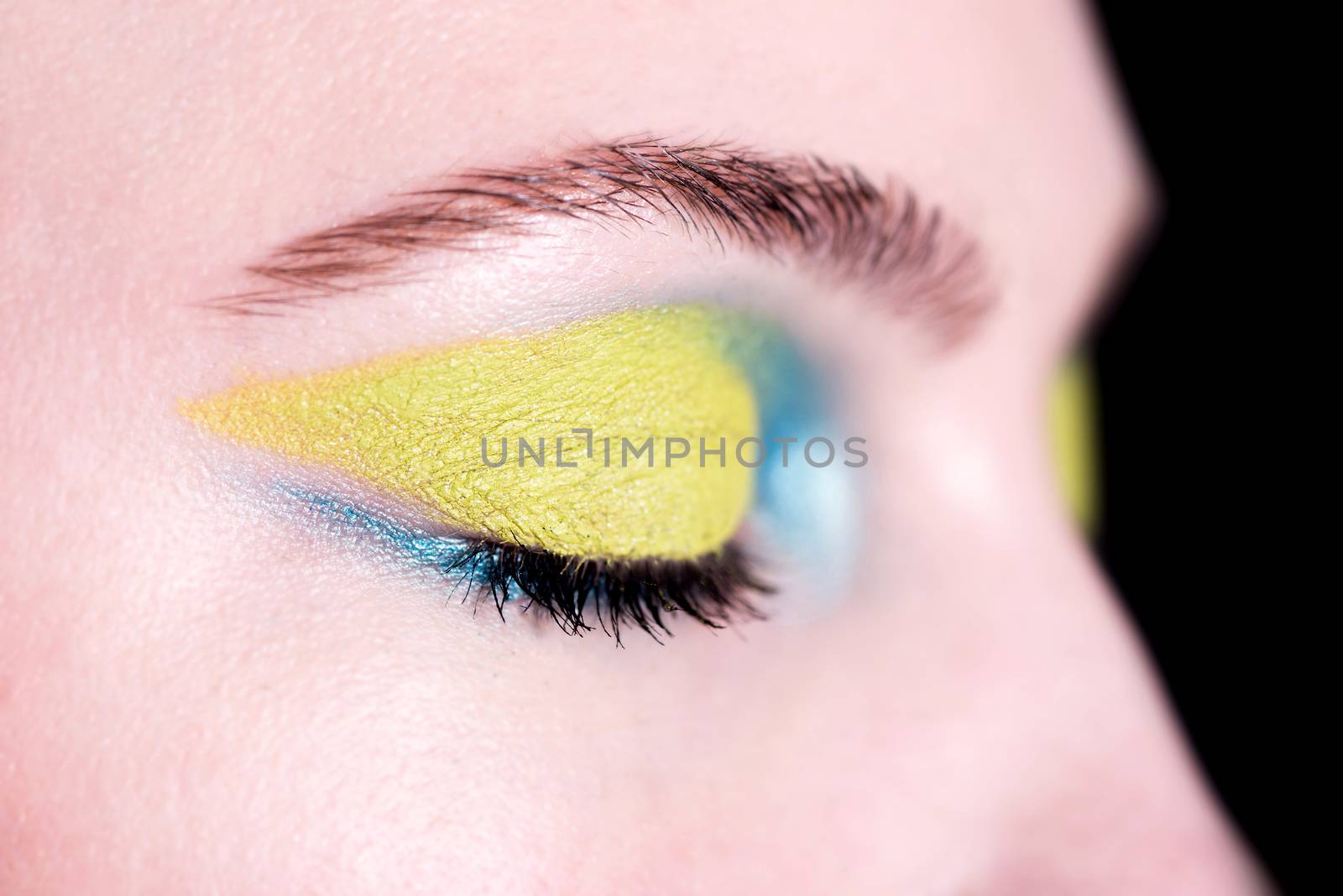 Closeup face of beautiful woman with bright fashion makeup
