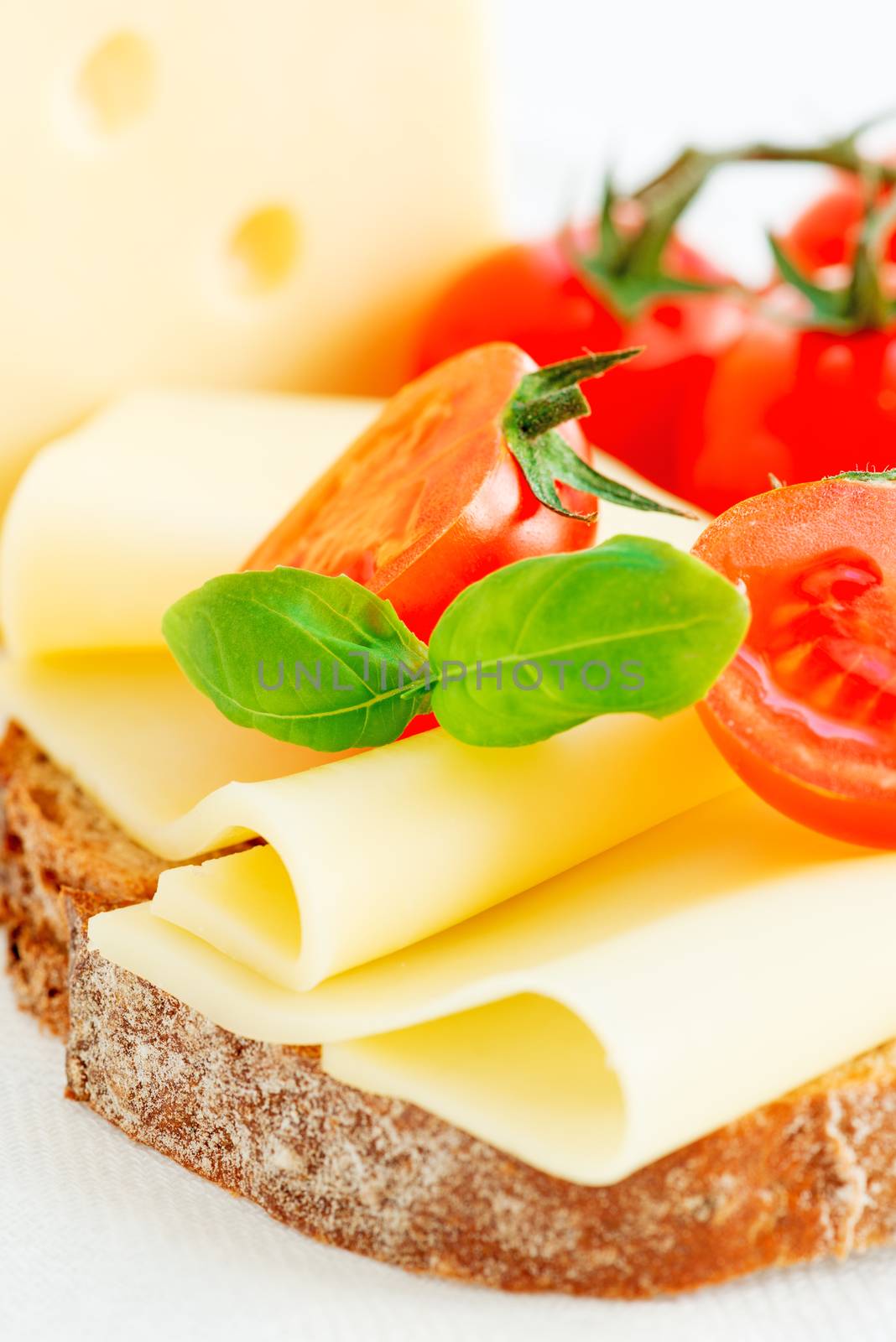 Cheese sandwich with fresh tomato and basil close up by Nanisimova