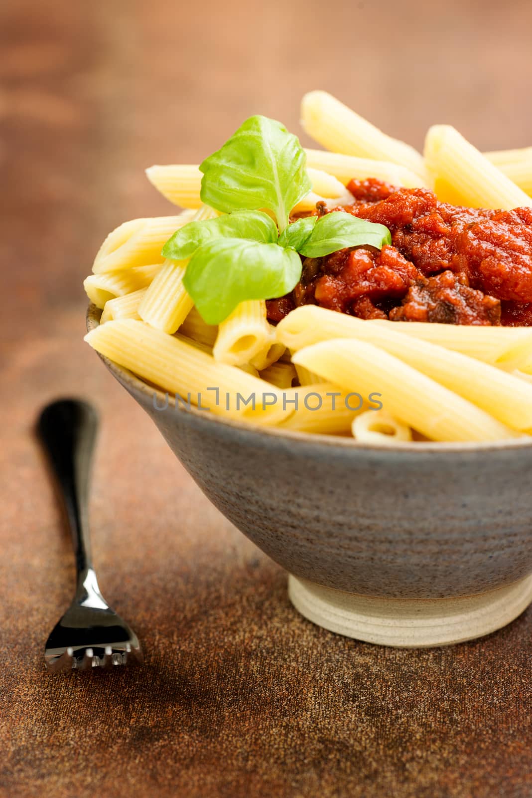 Penne pasta with a tomato bolognese beef sauce on the table