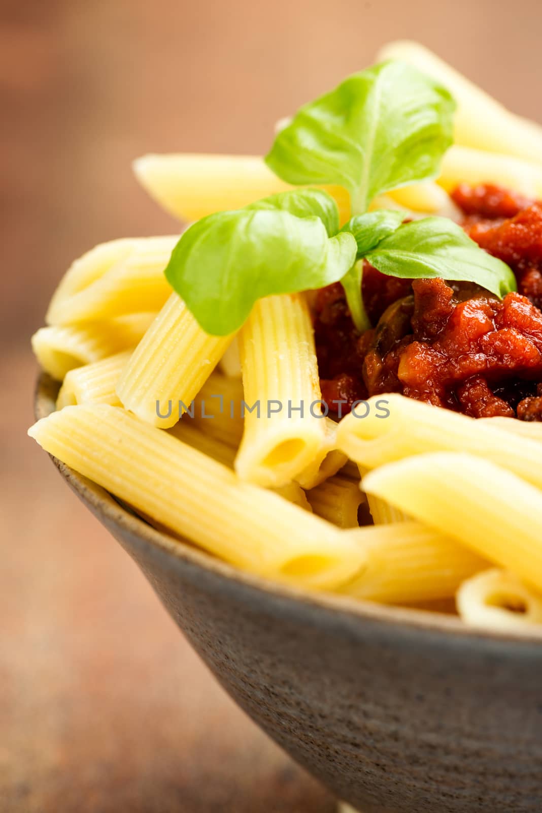 Penne pasta with a tomato bolognese beef sauce on the table