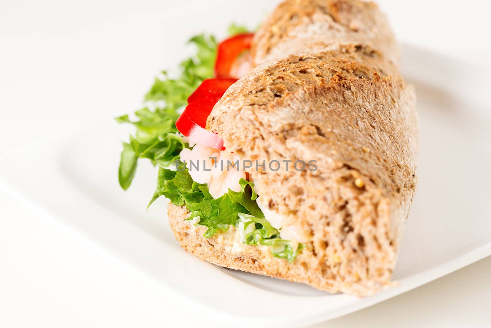 Prawn sandwich on white plate close up by Nanisimova
