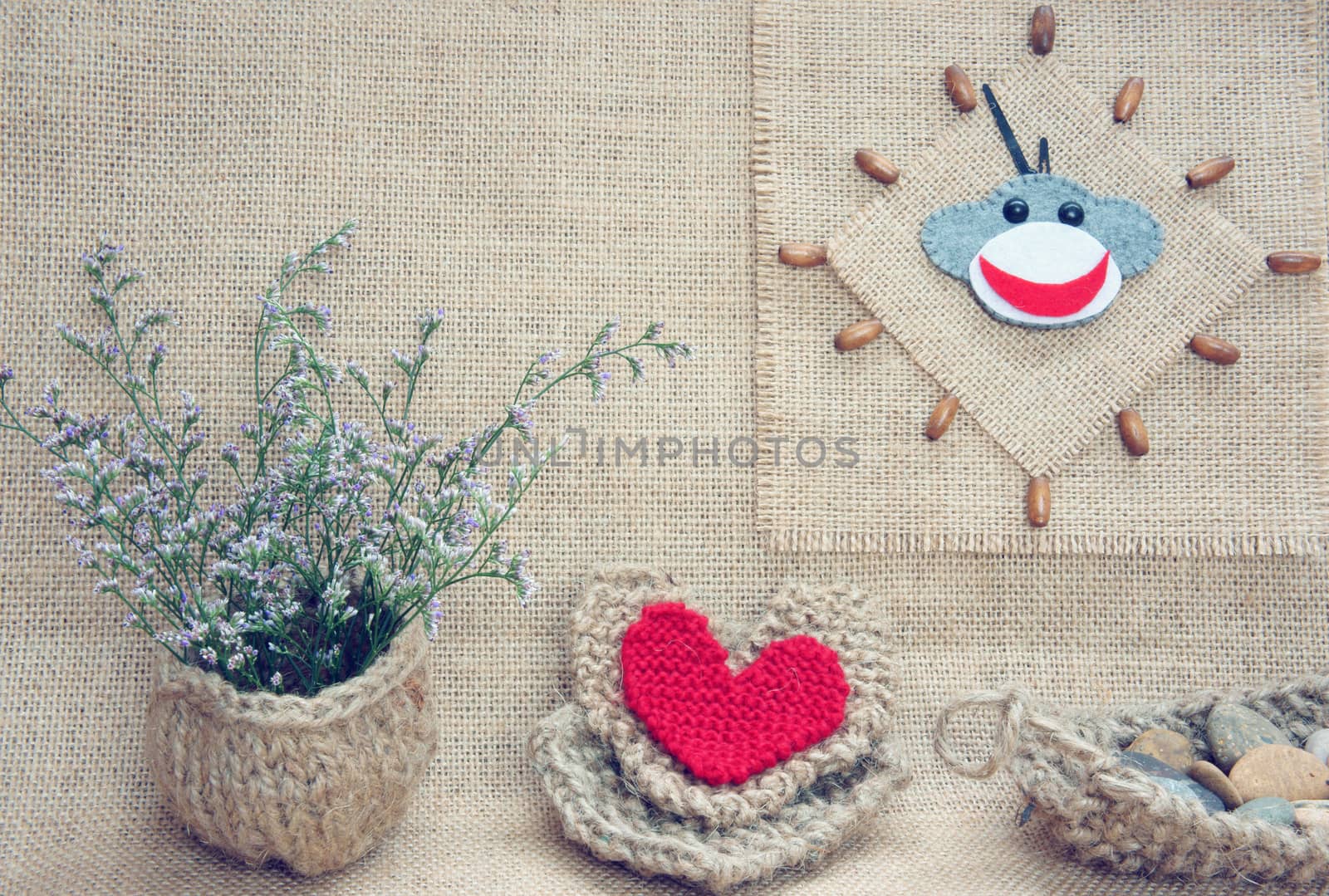 Art idea with funny monkey for happy new year 2016, new year eve time, handmade monkey face, clockwise on hand made clock, heart, flower decor on burlap background, vintage concept
