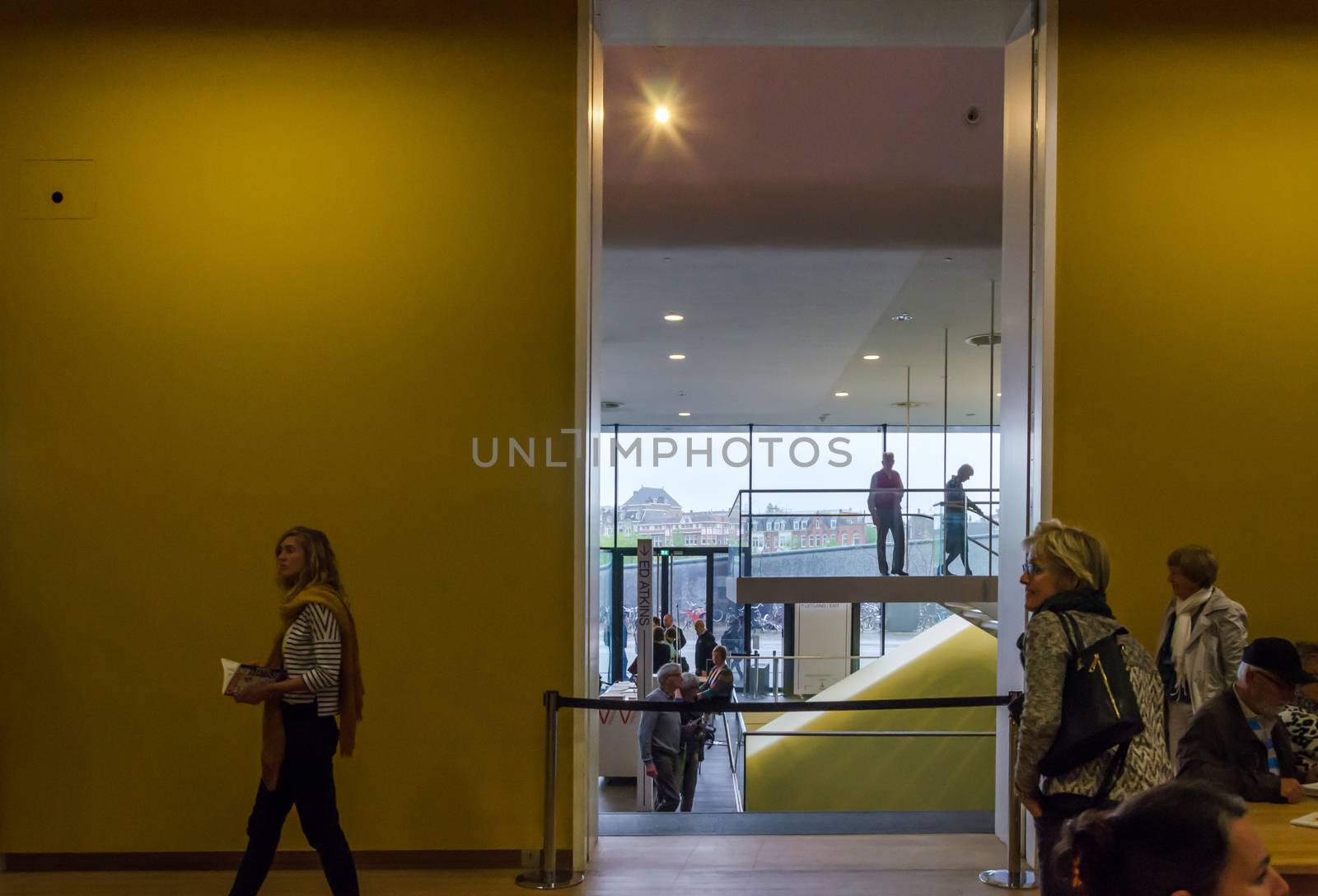 Amsterdam, Netherlands - May 6, 2015: People visit Stedelijk Musem in Amsterdam located in the museum park, Netherlands on May 6, 2015.