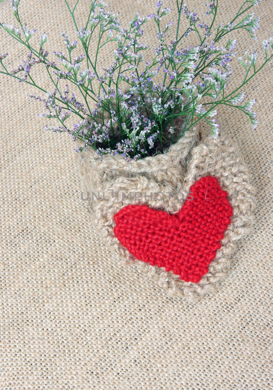 Amazing idea to decor by handmade product, flower pot, heart shape knitted from rope, beautiful flower on burlap background, use valentine day, or thank you idea, vintage style