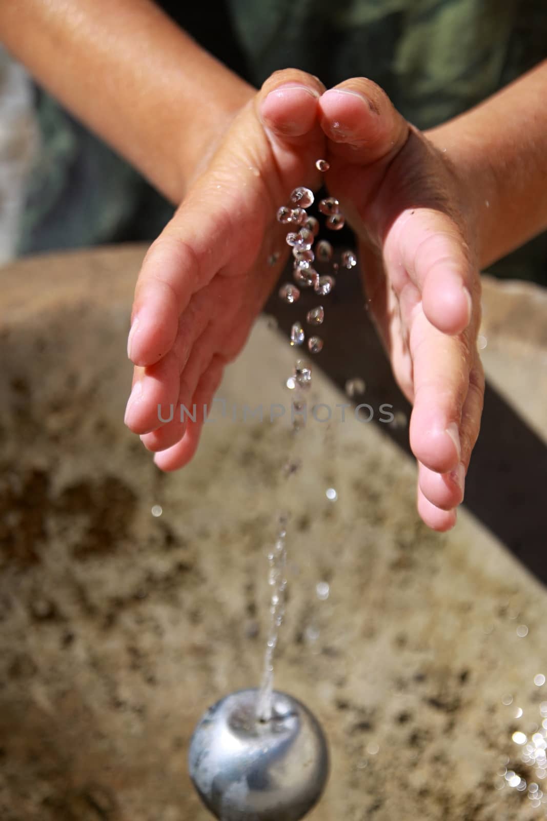 Woman's hands with cold drink water splash 