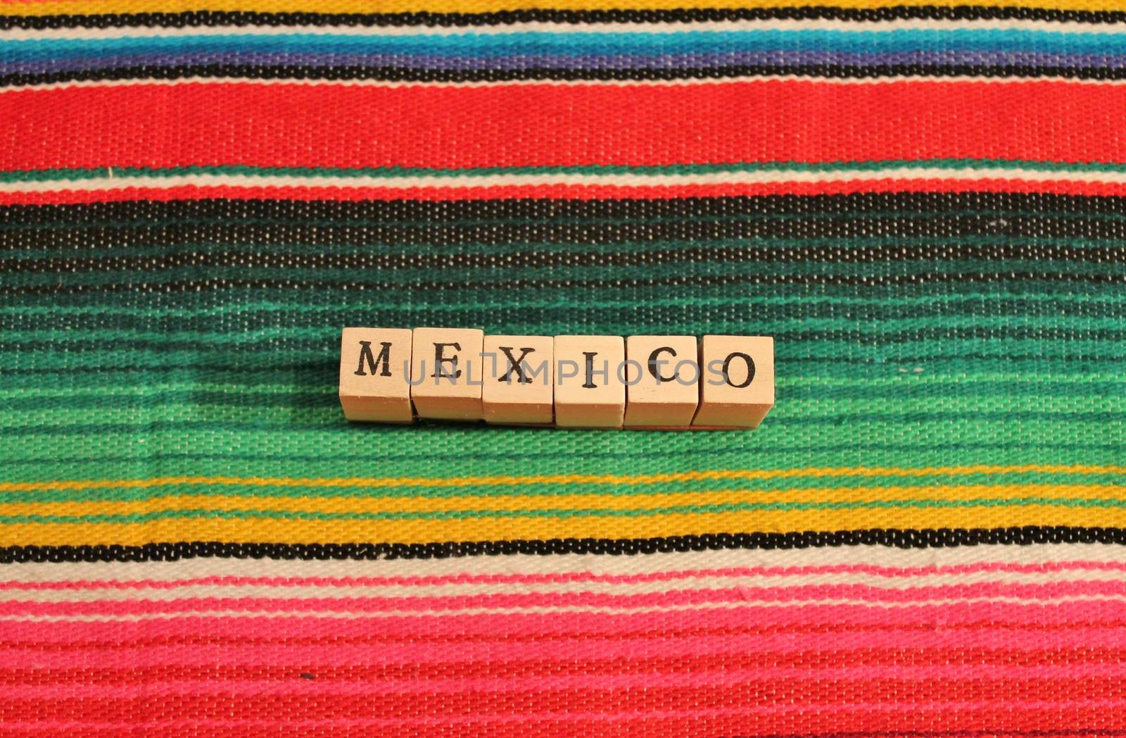 Word Mexico fiesta poncho rug in bright stripe background with copy space by cheekylorns