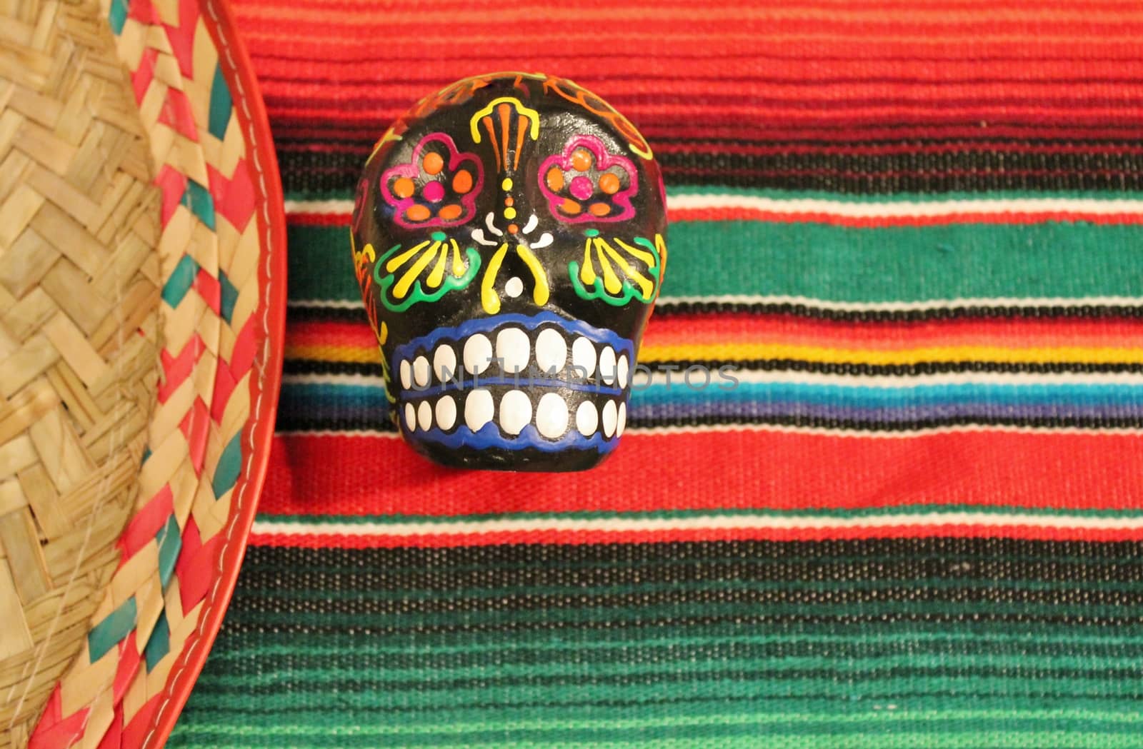 Mexico fiesta poncho sombrero sugar skull striped background with copy space by cheekylorns