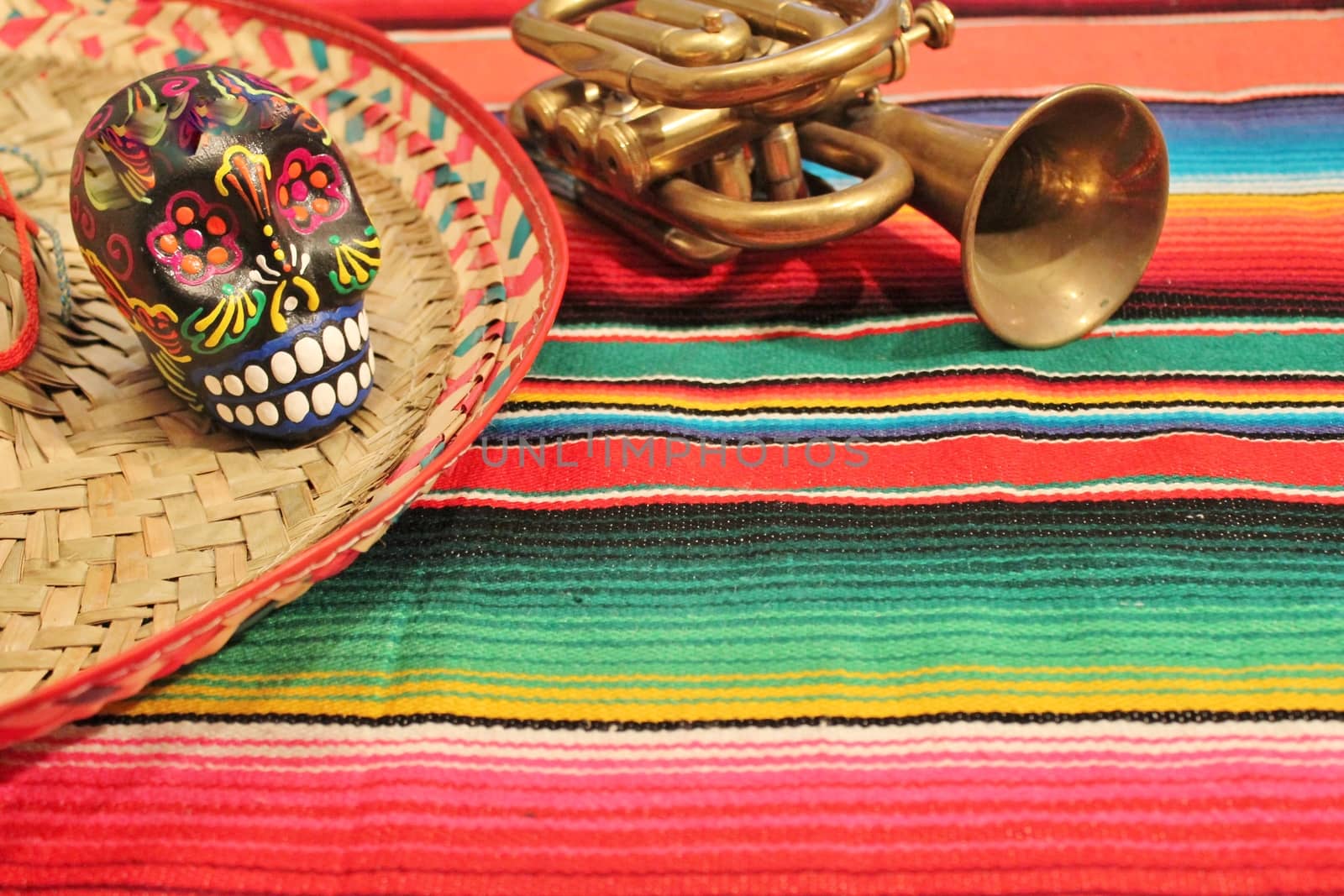 Mexico fiesta poncho candy skull sombrero in bright stripe background with copy space