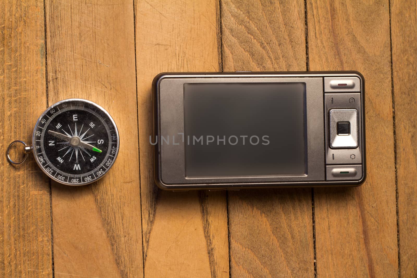 smartphone and compass on wooden background by max51288