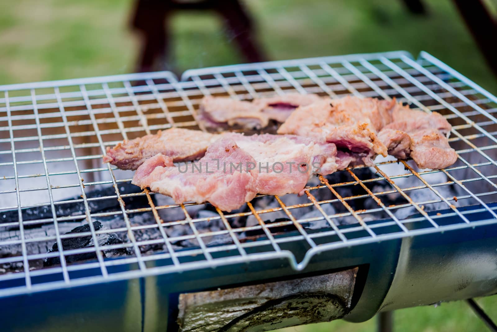 meat being grilled outdoors