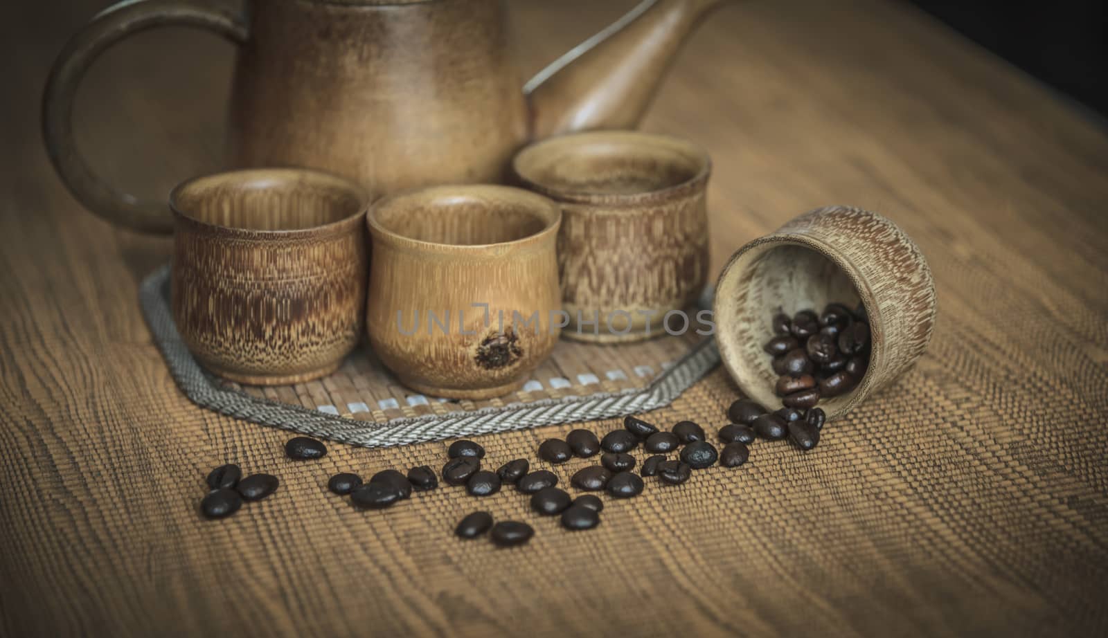 Vintage photo of coffee beans and Coffee cups set on wooden background.Vintage style.