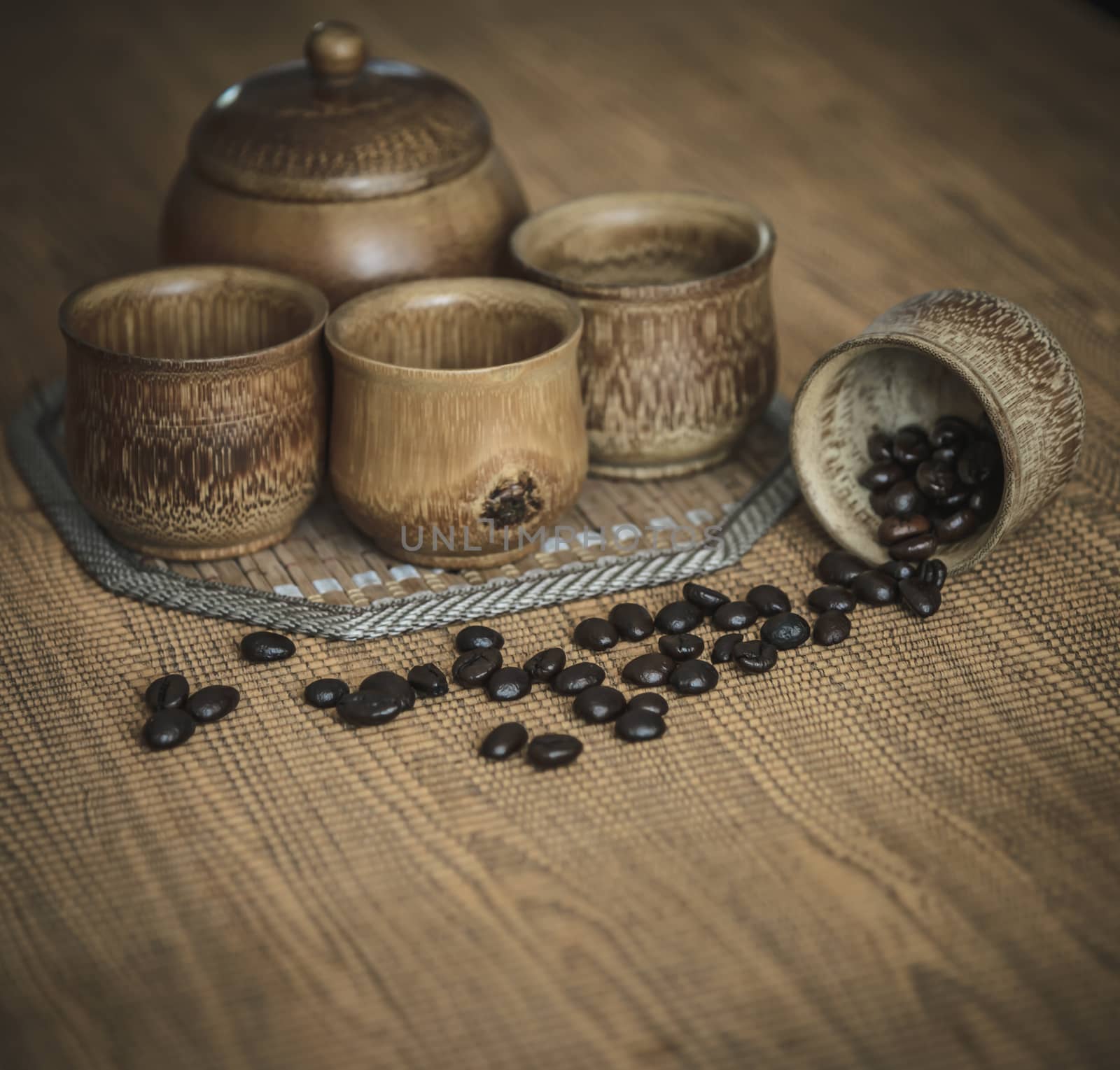 Vintage photo of coffee beans and Coffee cups set on wooden background.Vintage style.