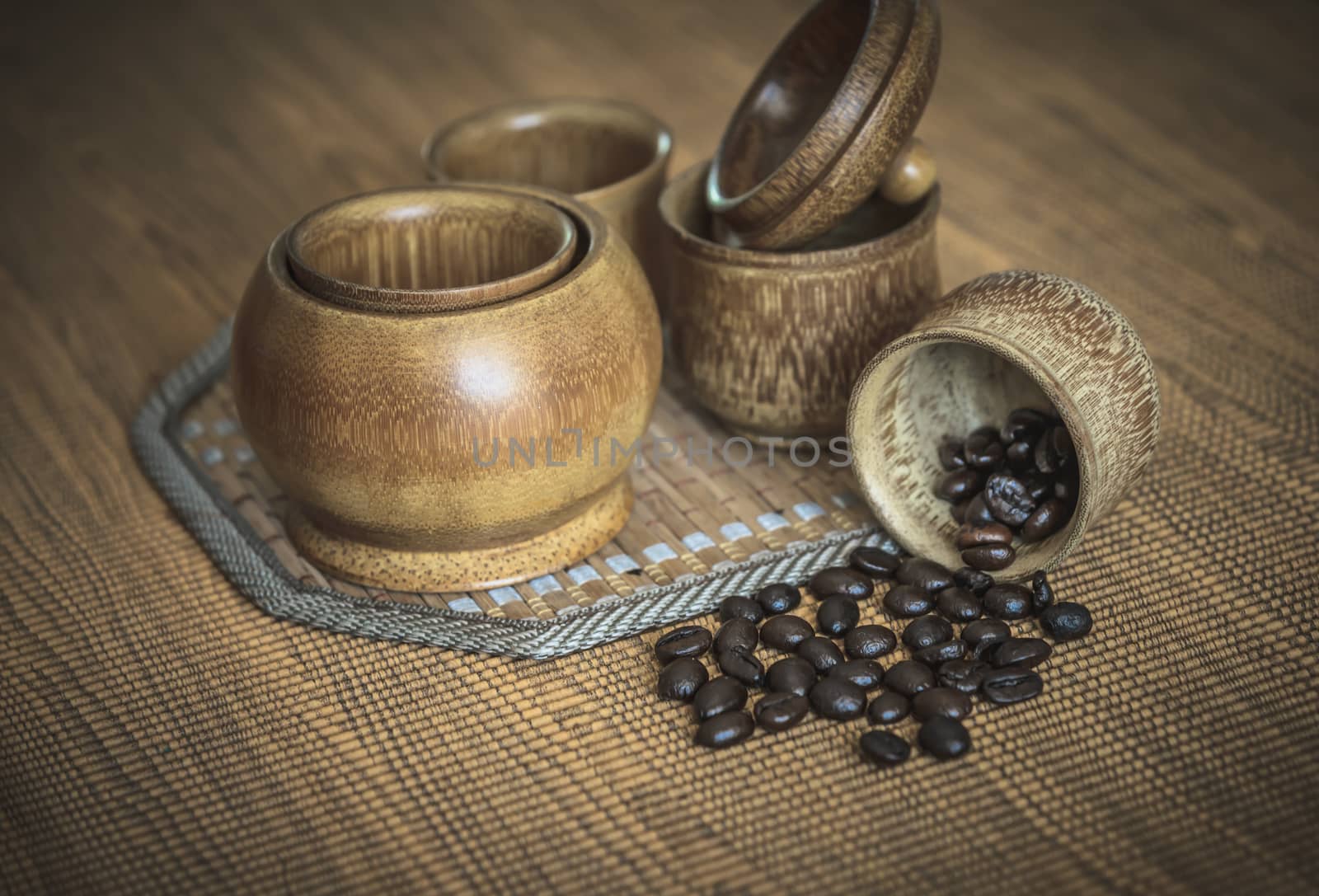 Vintage photo of coffee beans and Coffee cups set on wooden background.Vintage style.