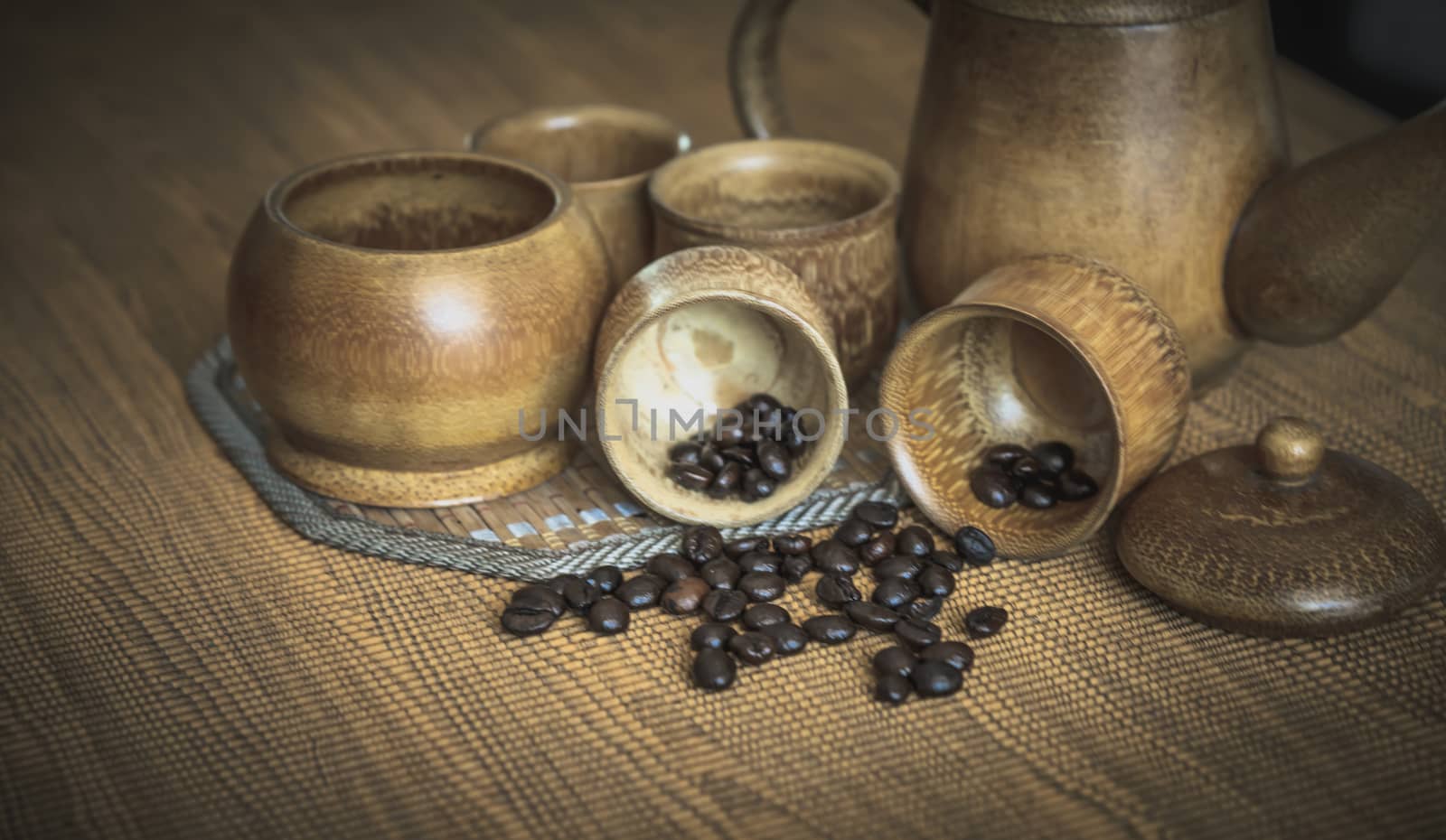 Vintage photo of coffee beans and Coffee cups set on wooden background.Vintage style.